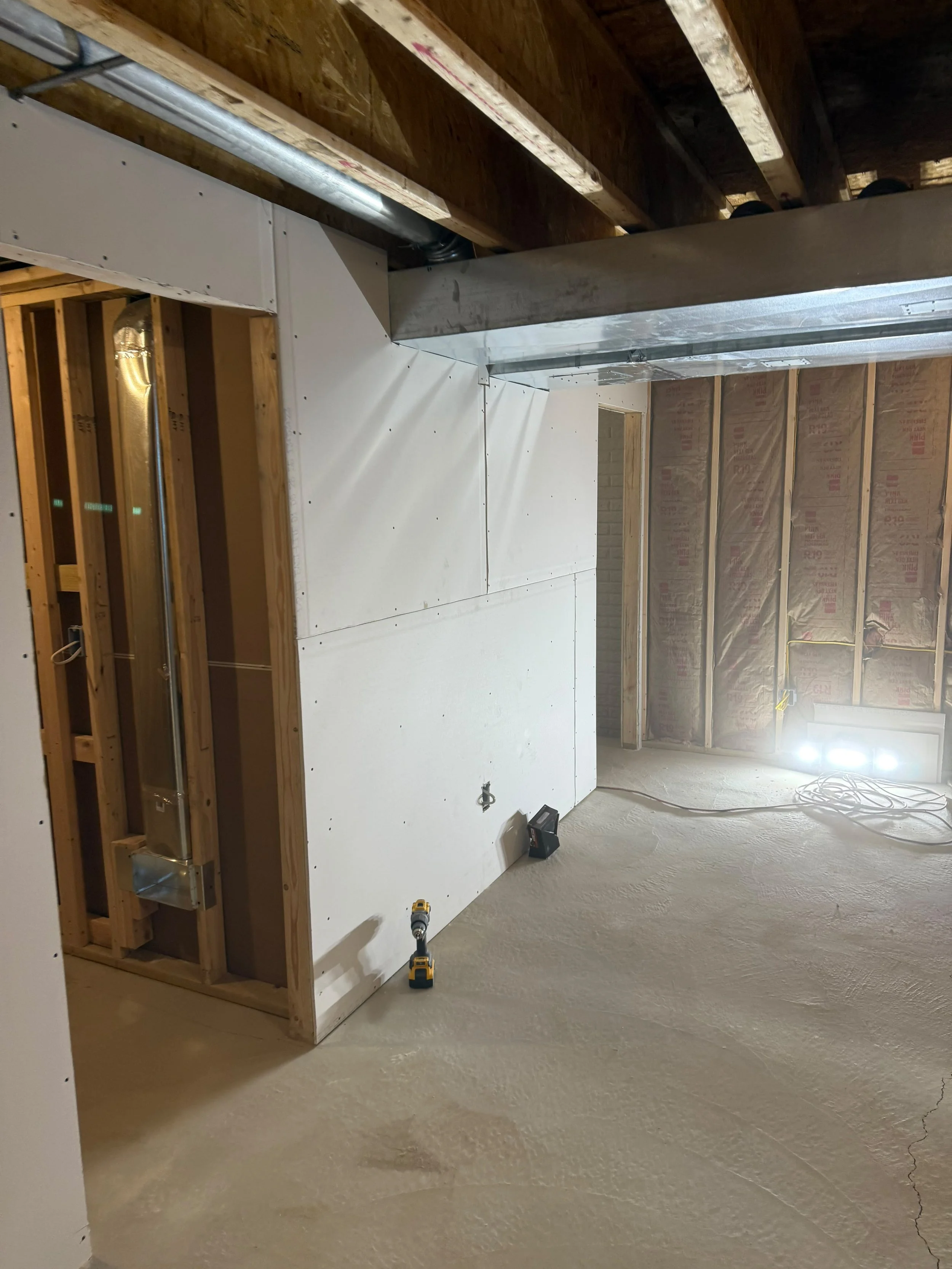Drywall completed and the space prepared for painting, flooring, trim, and final finishing touches.