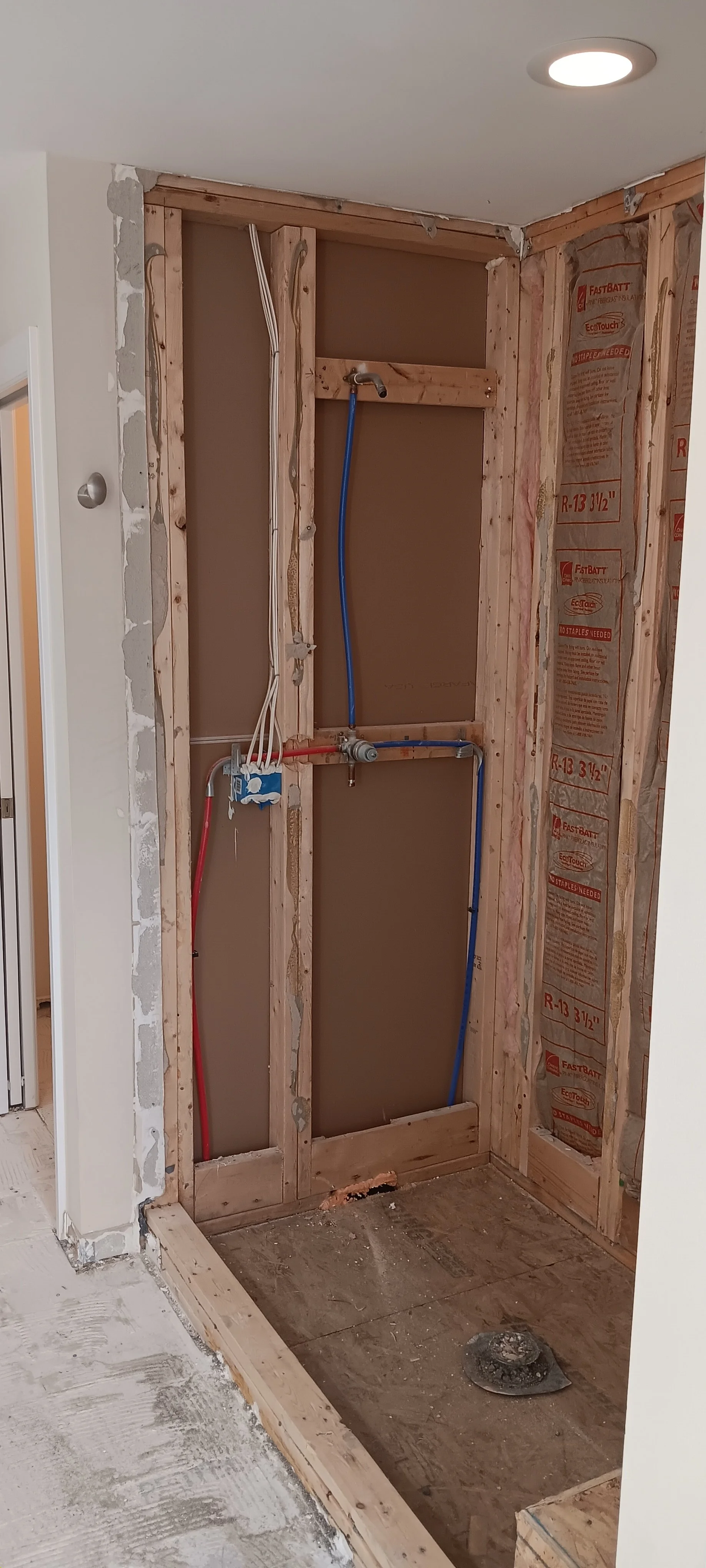 Shower area stripped to the framing during the remodeling process.