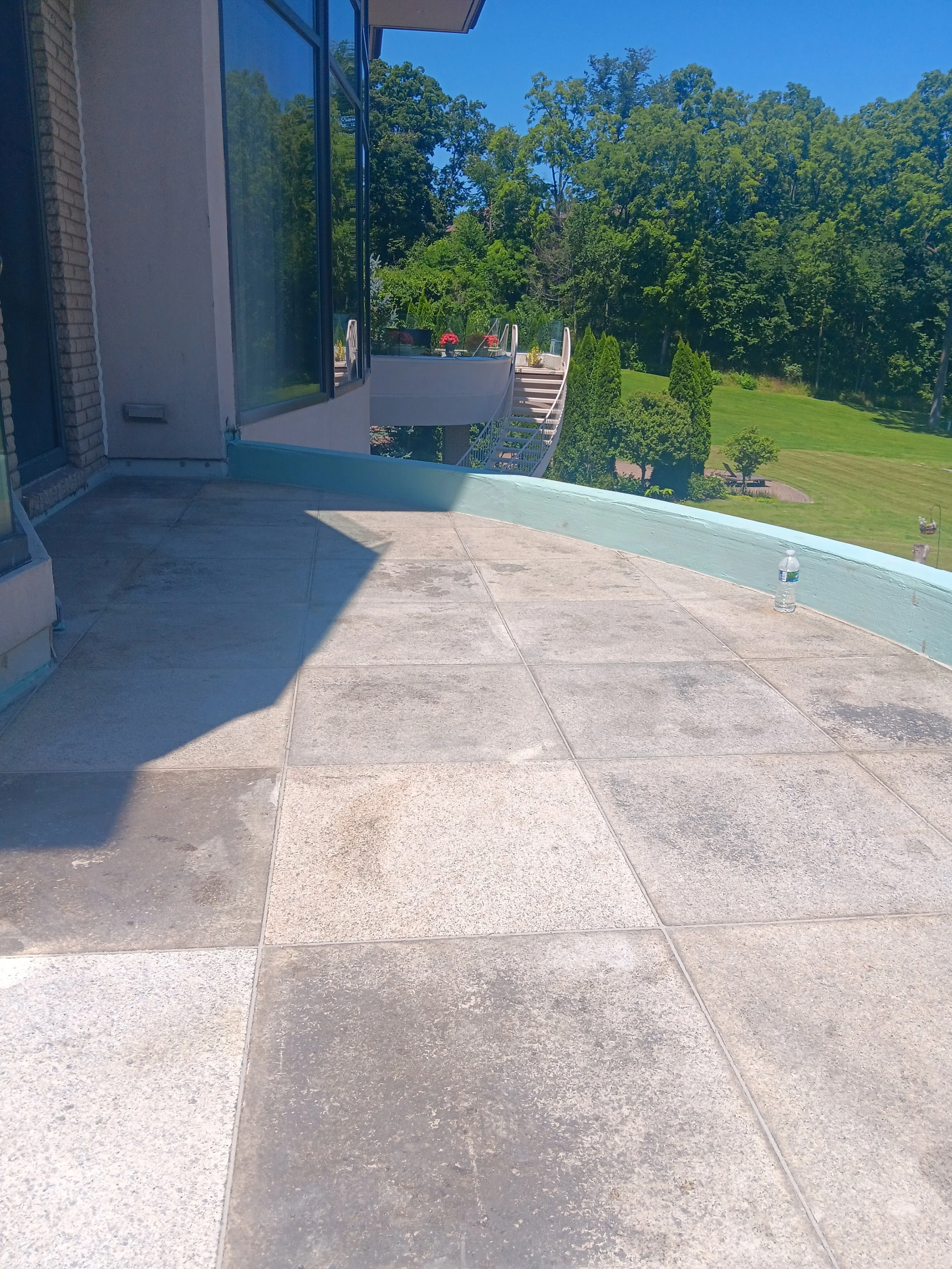 Restored balcony deck with a smooth waterproof surface and clean curved perimeter.