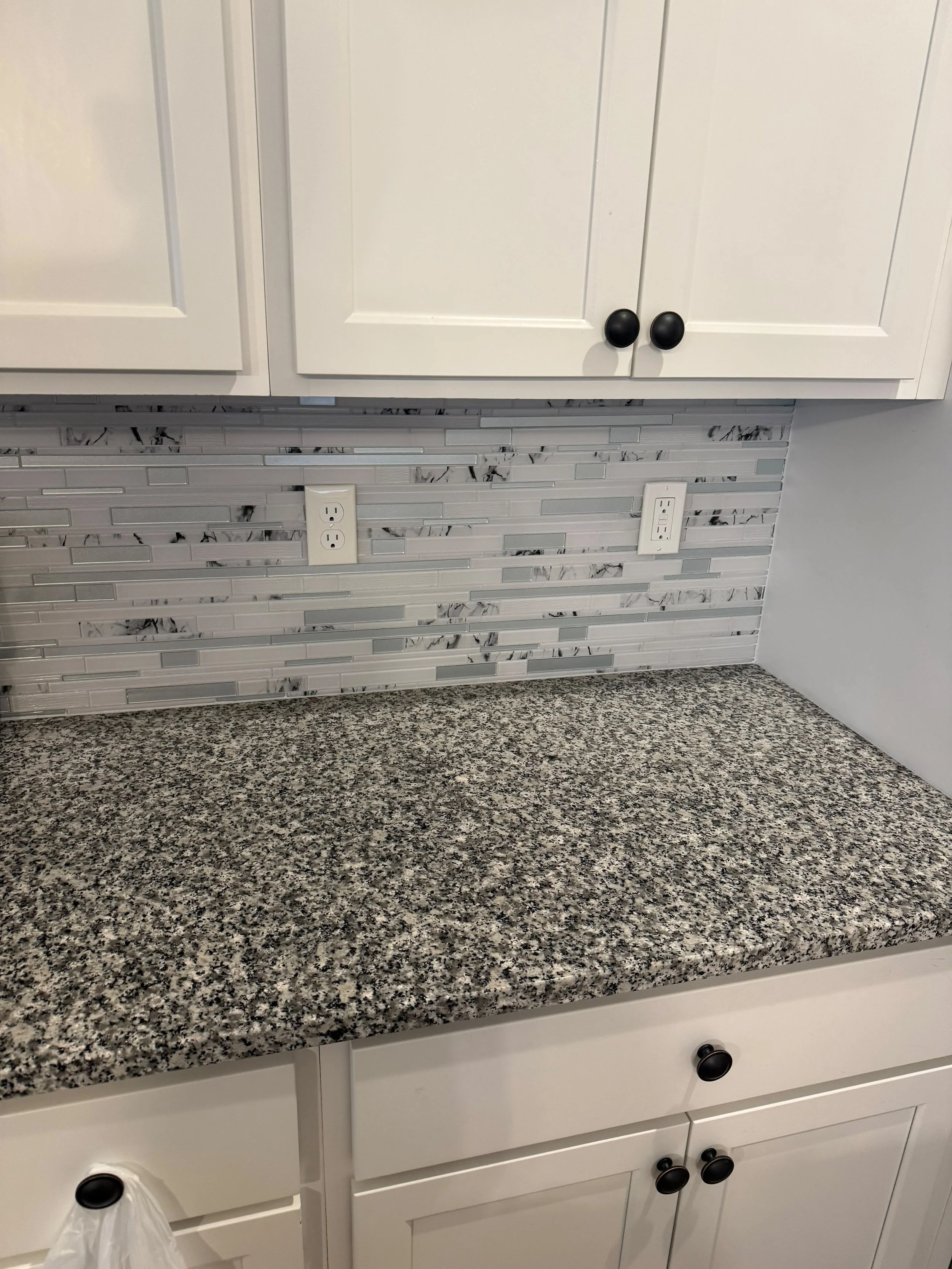 From backsplash installation to countertop upgrades, this project showcases expert craftsmanship and attention to detail. The finished kitchen combines timeless design with durable materials for years of enjoyment.