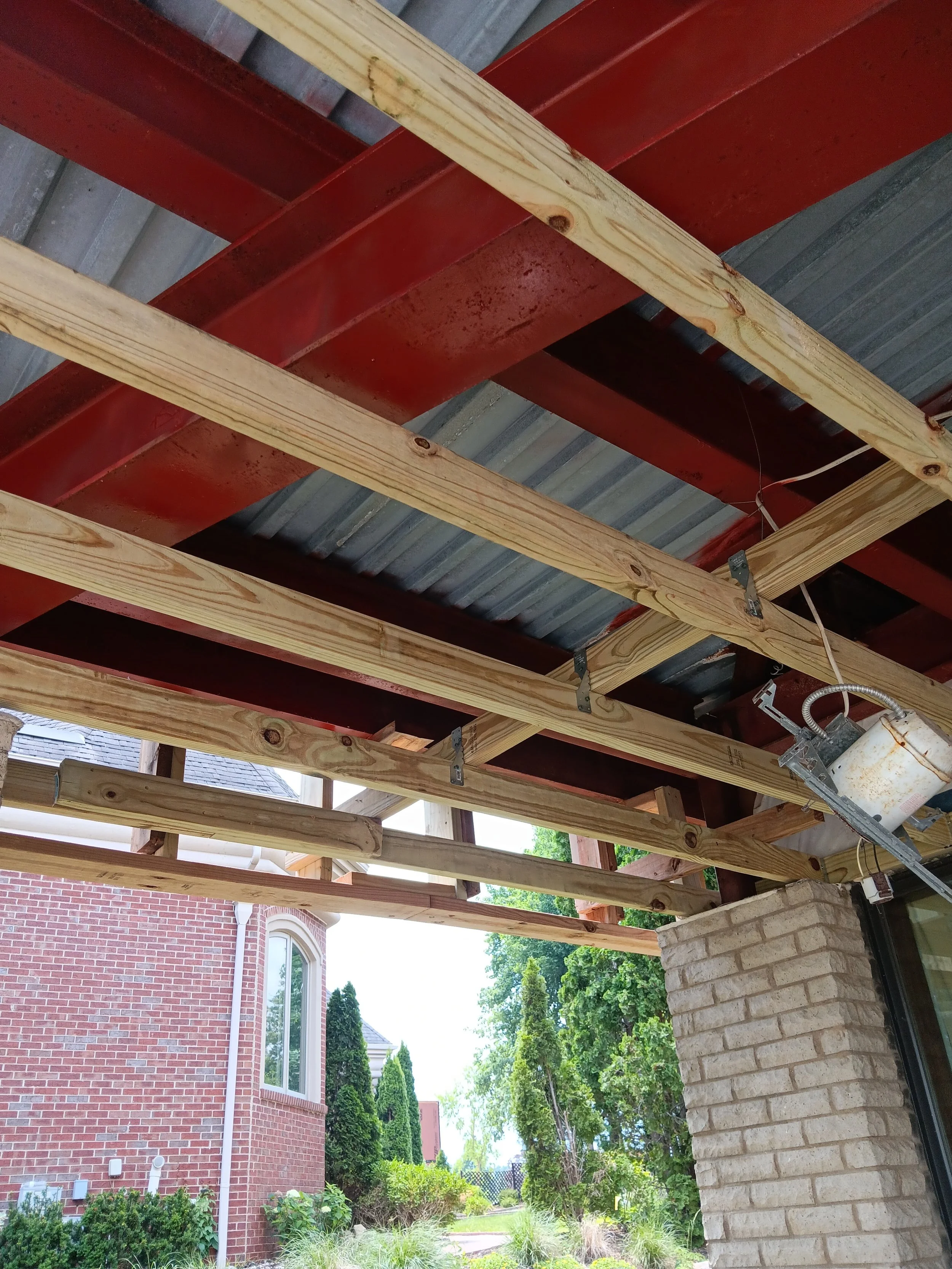 Close-up view of the exposed balcony framing and support structure during reconstruction.