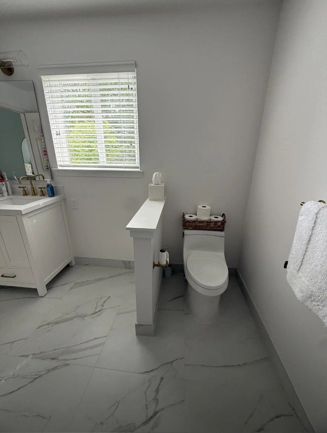 The redesigned bathroom layout offers a bright, open feel with premium flooring, modern fixtures, and a functional design for everyday living.