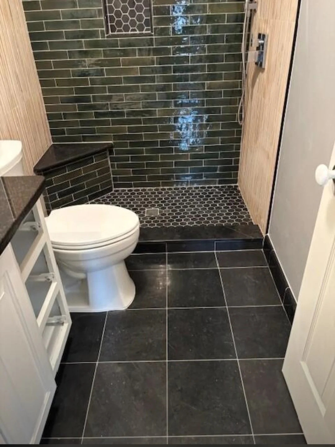 New floor tile and matching wall finishes bring together a clean , sophisticated design that is both stylish and easy to maintain.