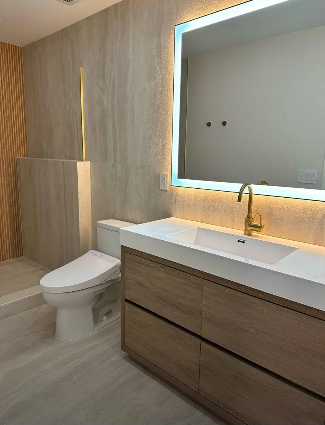 Warm LED backlighting and contemporary fixtures add a sophisticated touch, creating a relaxing spa-like atmosphere.