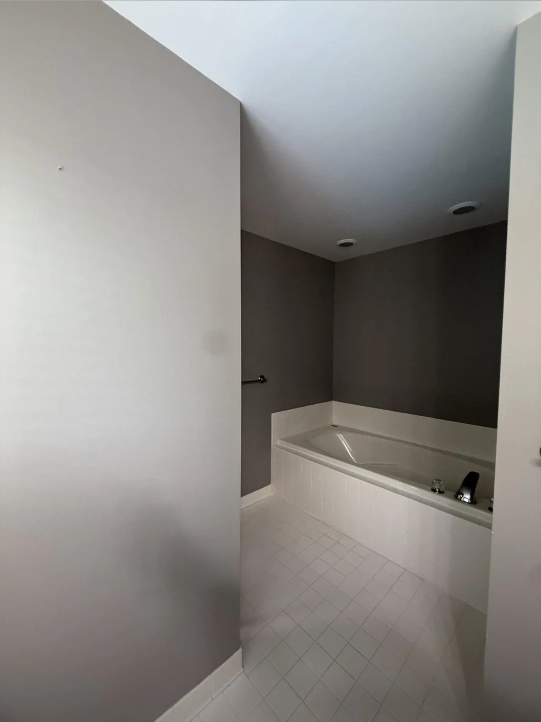 A beautiful freestanding soaking tub provides the perfect place to relax, adding elegance and comfort to the remodeled bathroom.