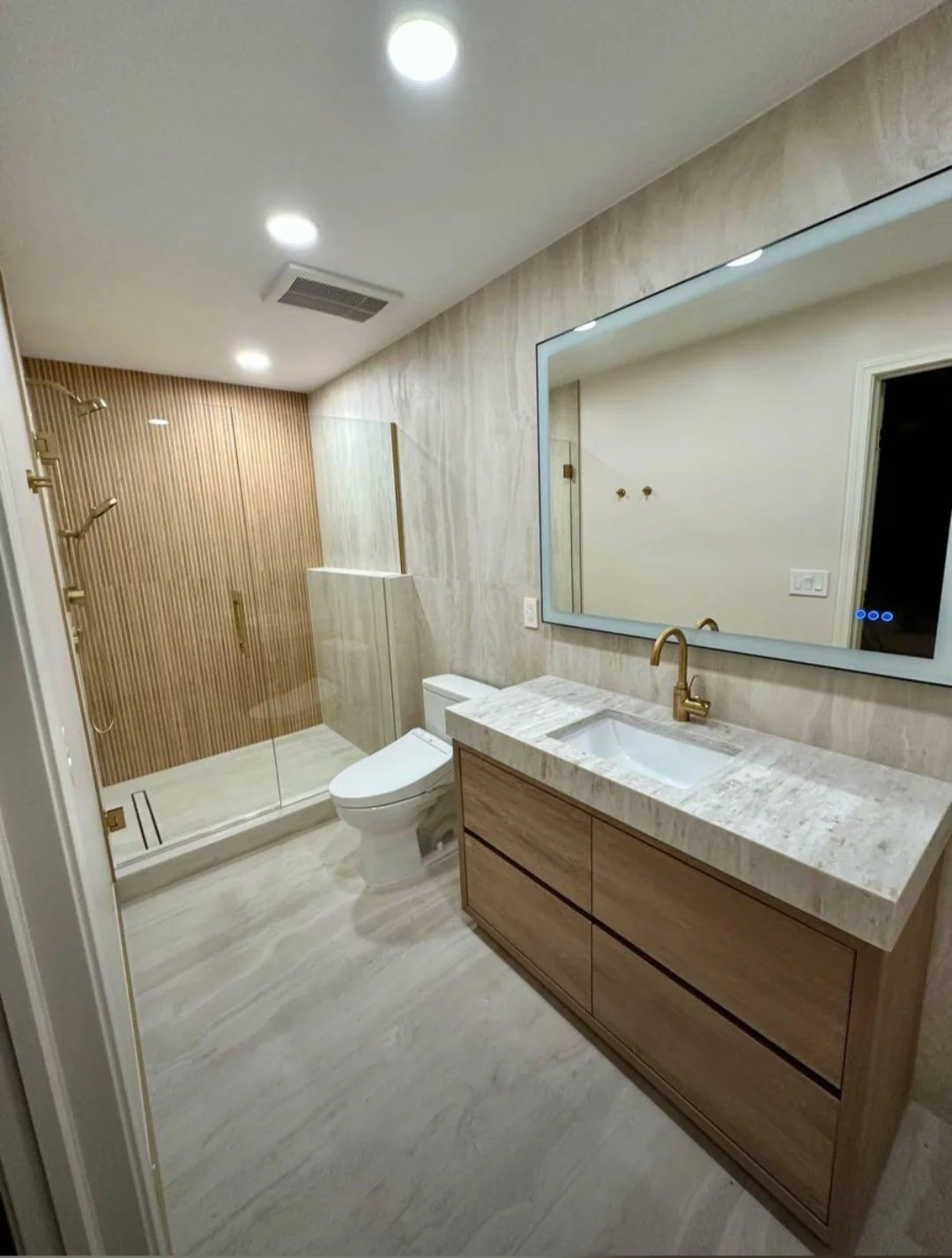 A sleek, modern bathroom featuring a custom floating vanity, spacious countertop, and premium finishes designed for every luxury.
