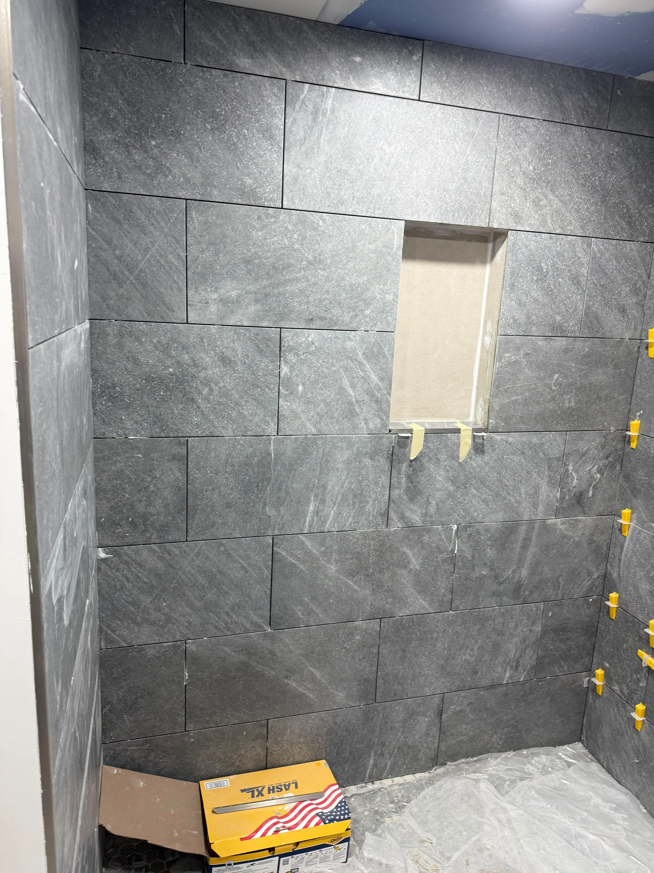 Premium tile installation with a built-in shower niche, combining luxury design with everyday functionality.