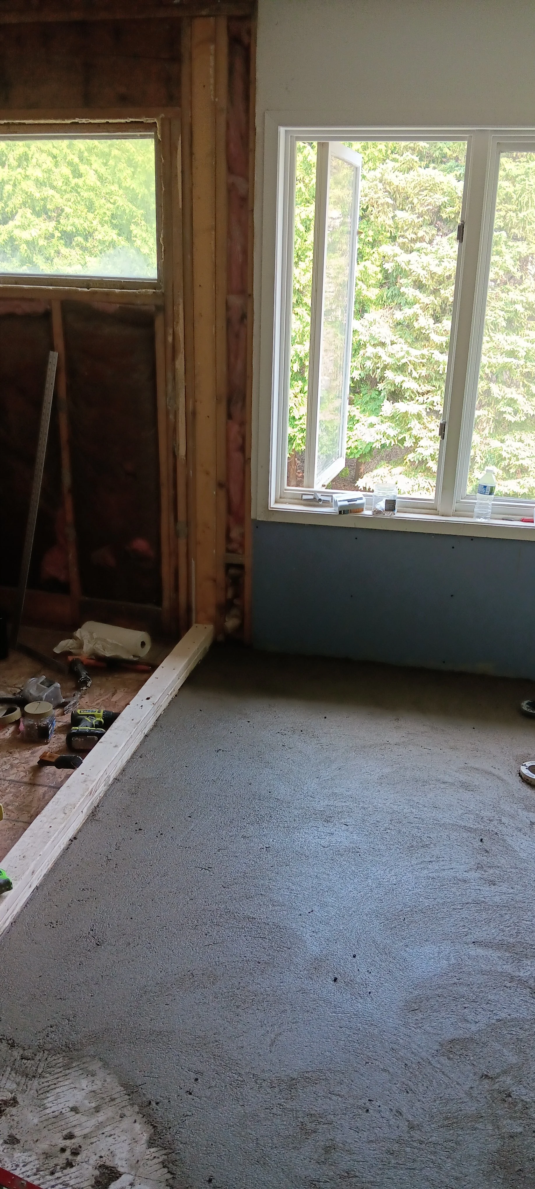 Bathroom floor and walls prepared for the next stage of the remodeling process.