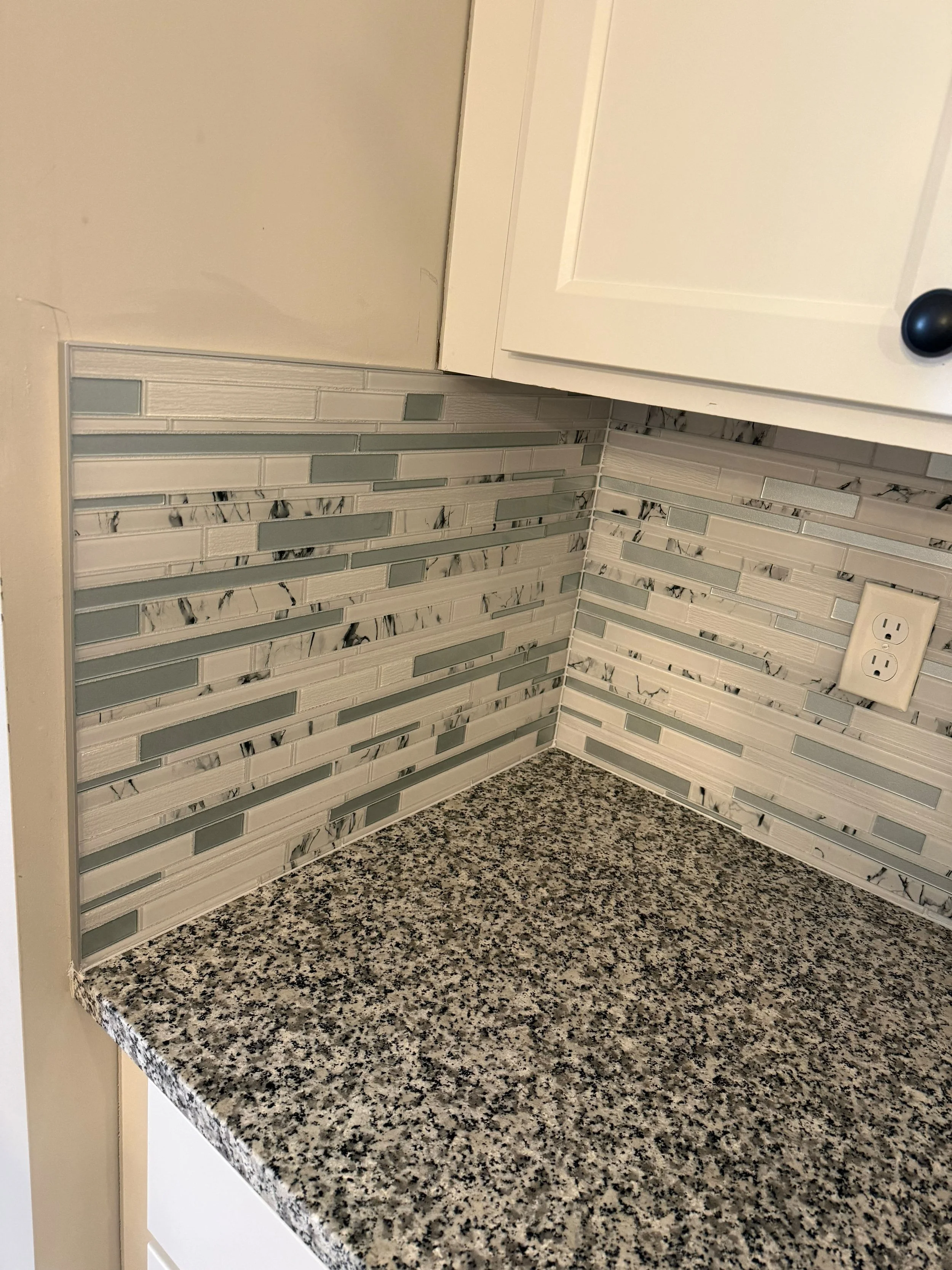 This kitchen was refreshed with a modern tile backsplash, durable granite countertop, and beautifully refinished cabinetry. Every detail was carefully installed to create a space that is both stylish and practical for everyday living.