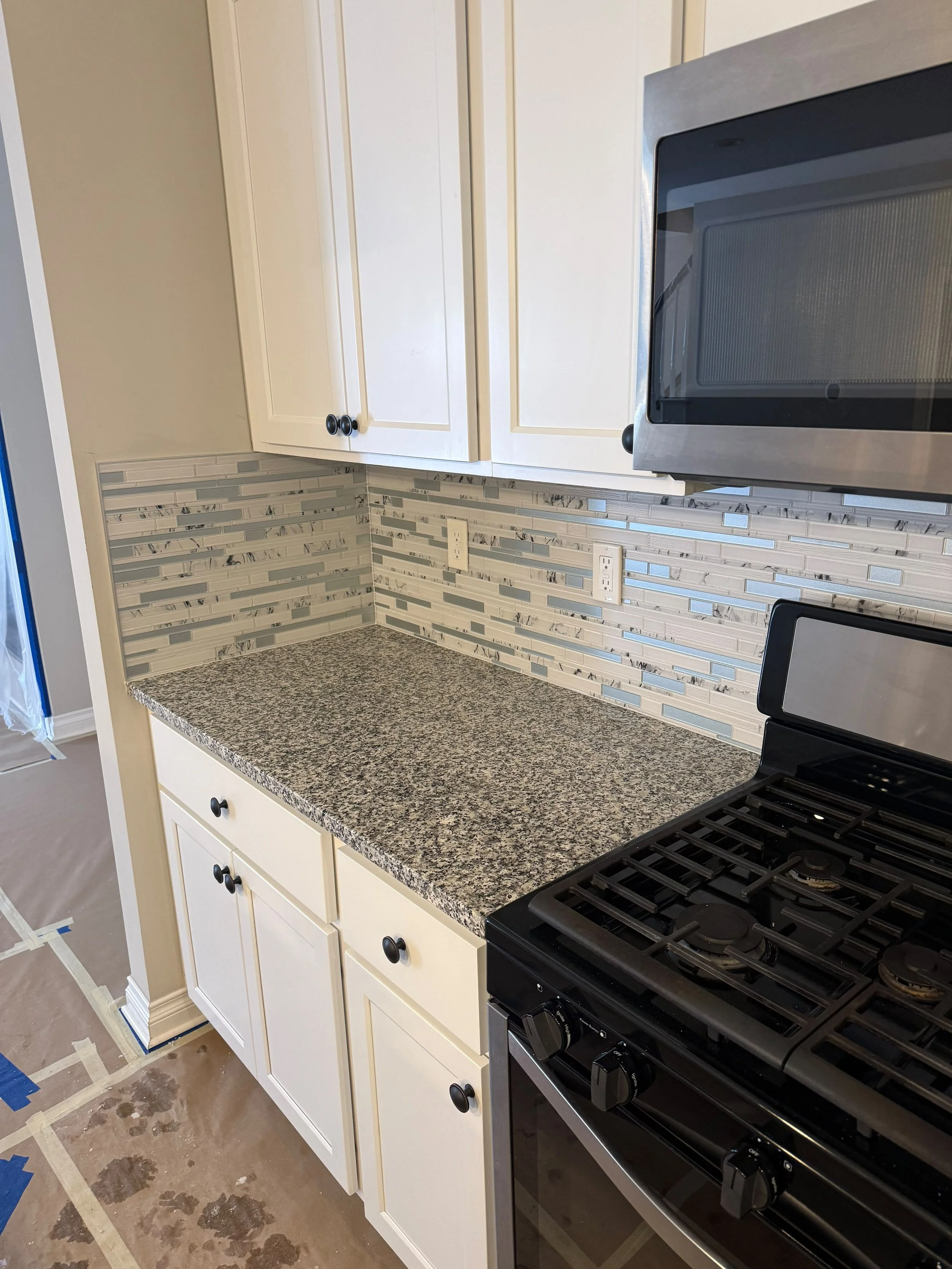 A clean and elegant kitchen transformation featuring custom backsplash installation, premium countertops, and updatedfinishes. The result is a brighter, more functional kitchen designed to add lasting value to the home.