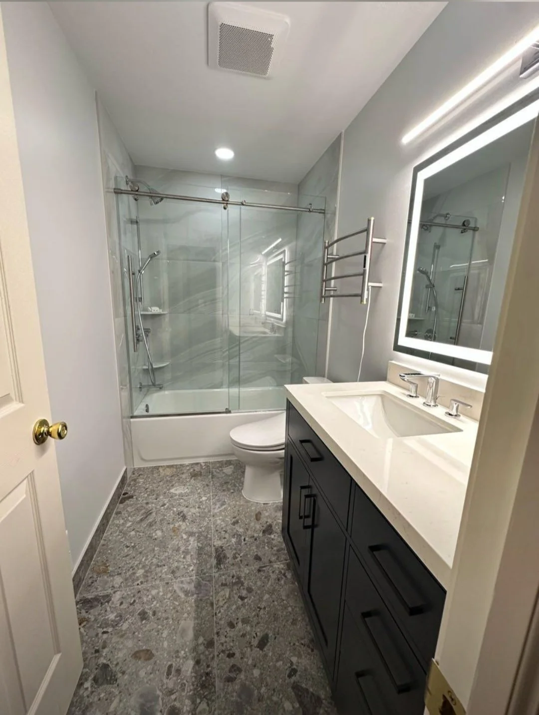 Premium tilework, a modern vanity, and carefully selected finishes transform this bathroom into a bright and elegant retreat.