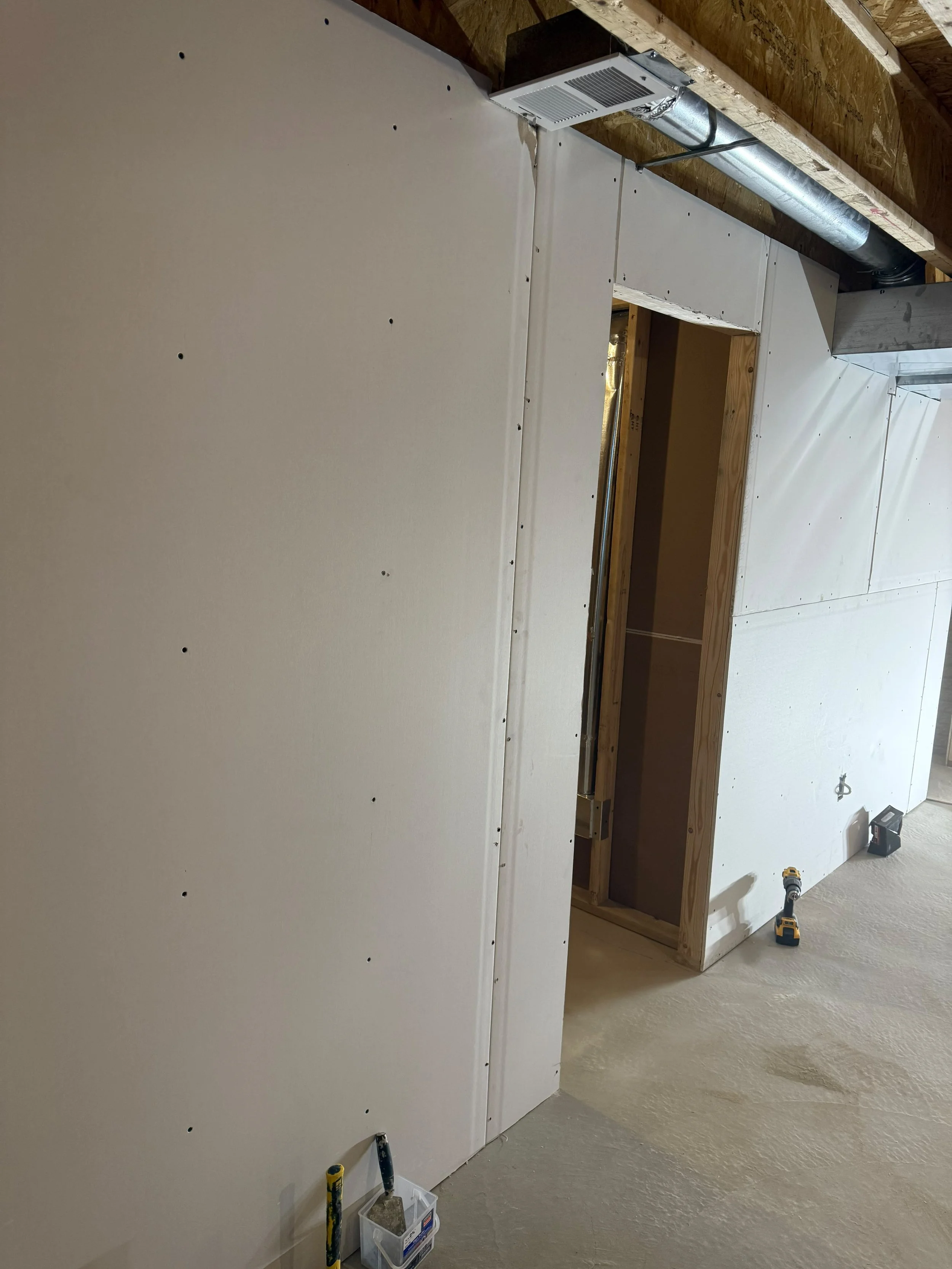 Walls enclosed with high-quality drywall, making the transition from structural work to a polished interior finish.