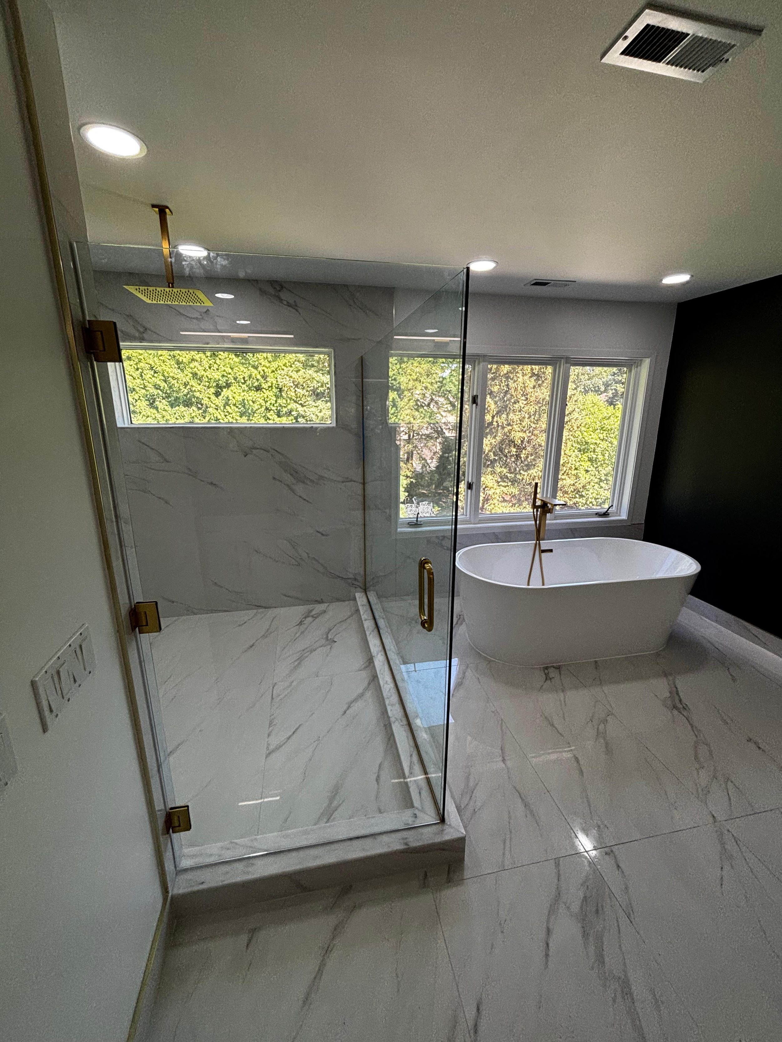 This project features a luxurious walk-in shower, freestanding bathtub, premium tile installation, sleek glass enclosure, and modern finishes, delivering a beautiful bathroom built to last.