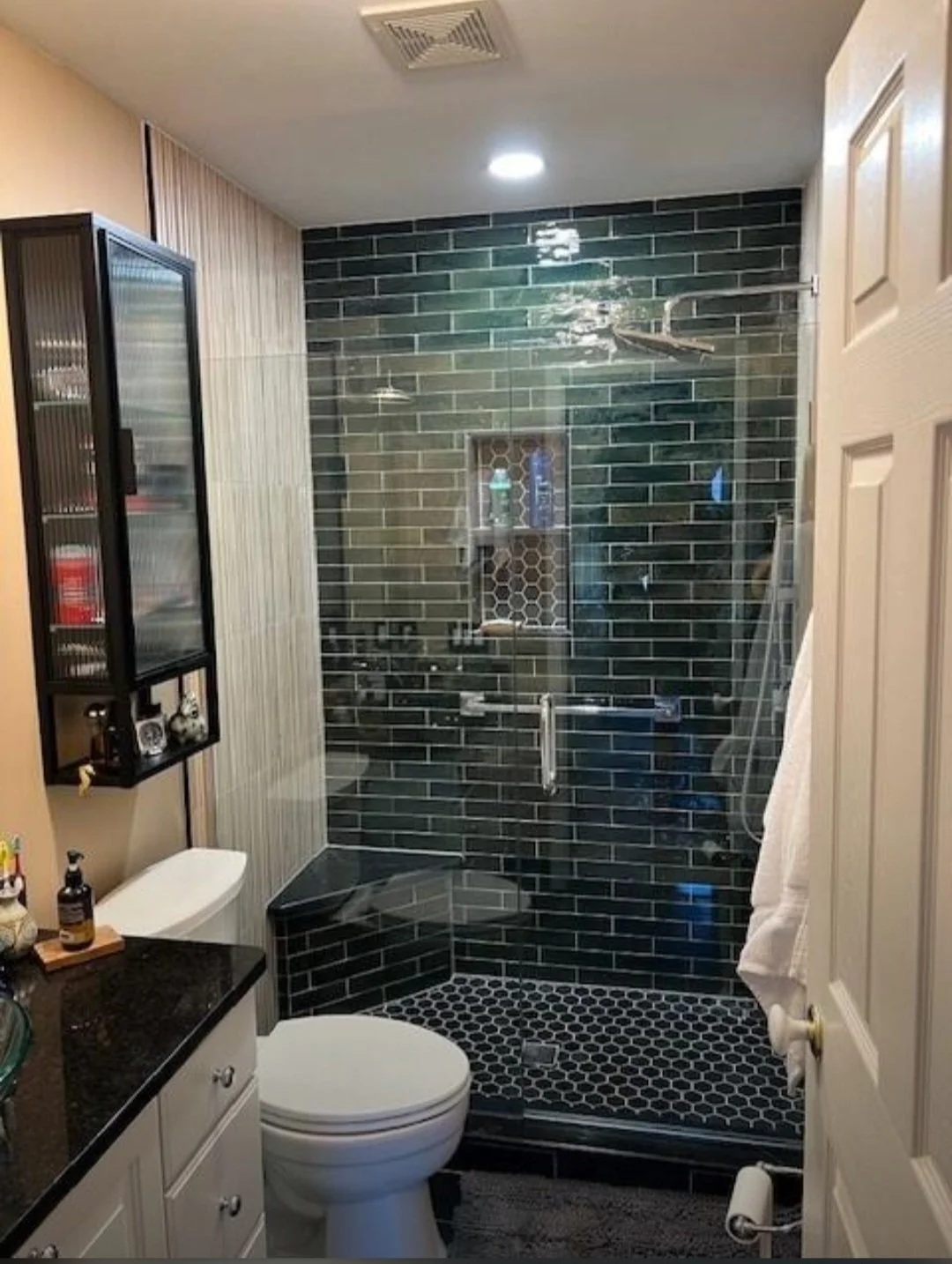 The completed bathroom showcases a stunning walk-in shower, modern fixtures, premium tilework, and a beutiful finished space designed for comfort and lasting quality.