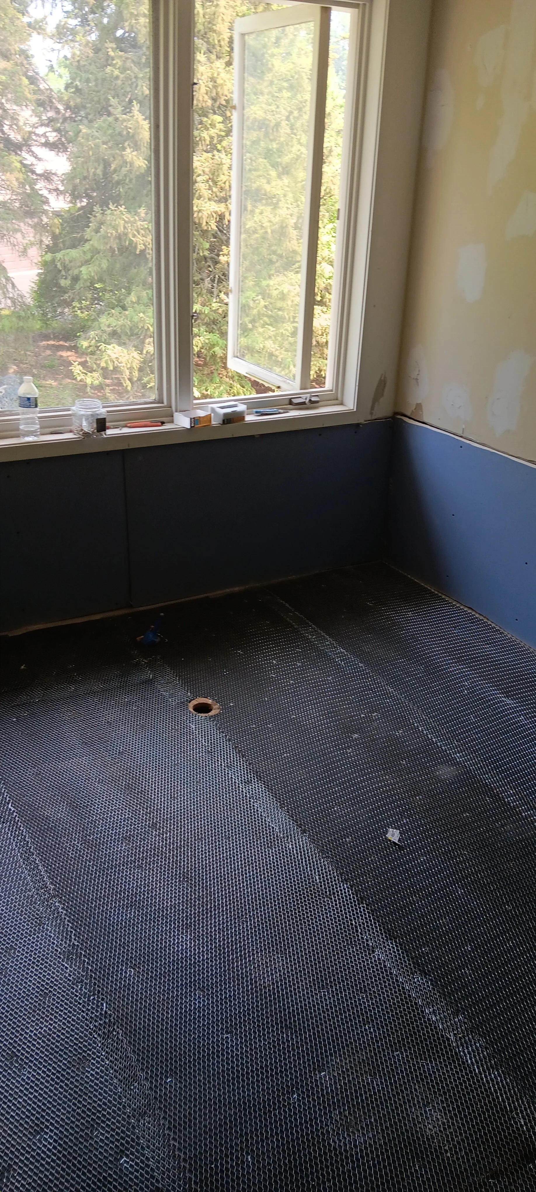New wall panels and flooring installed during the bathroom reconstruction.