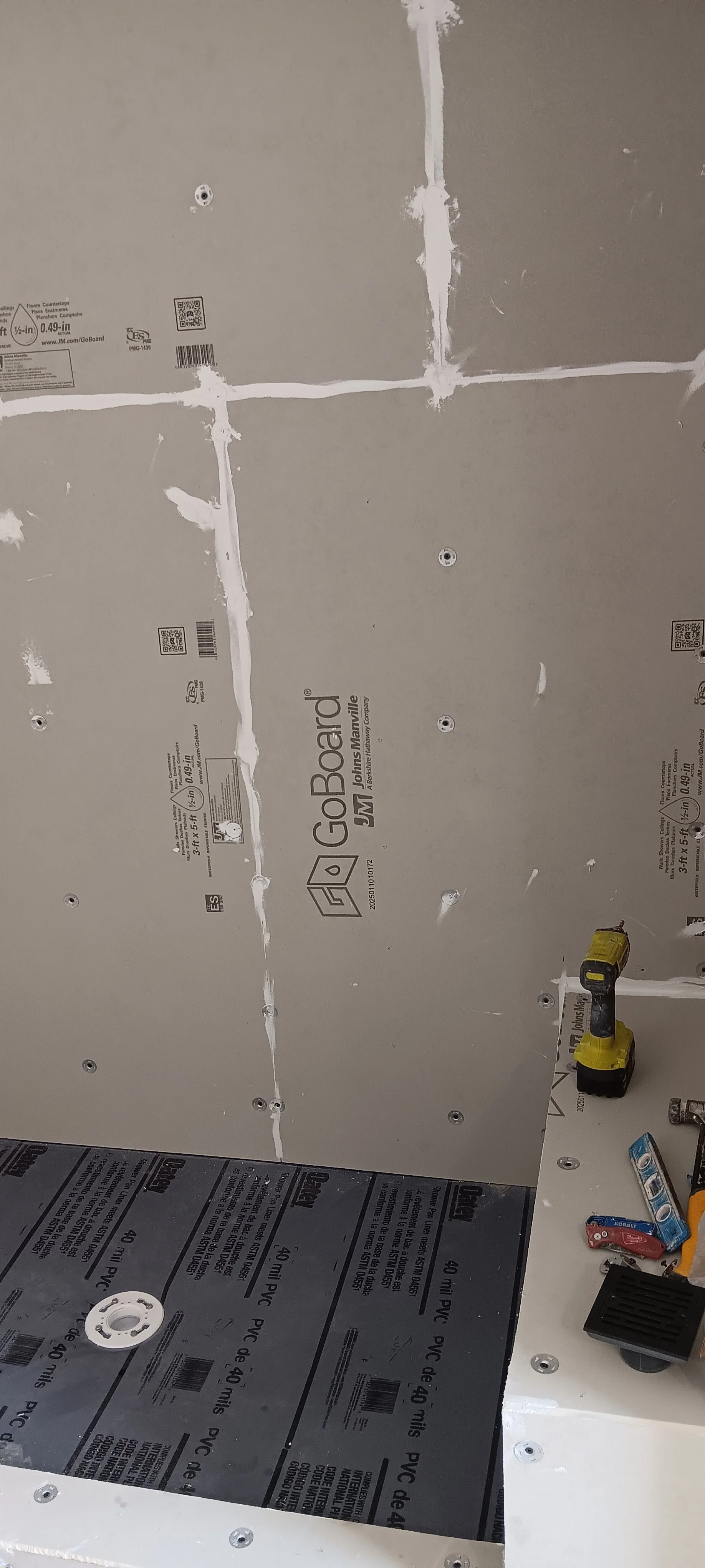 Waterproof shower base and cement-board walls ready for tile installation.