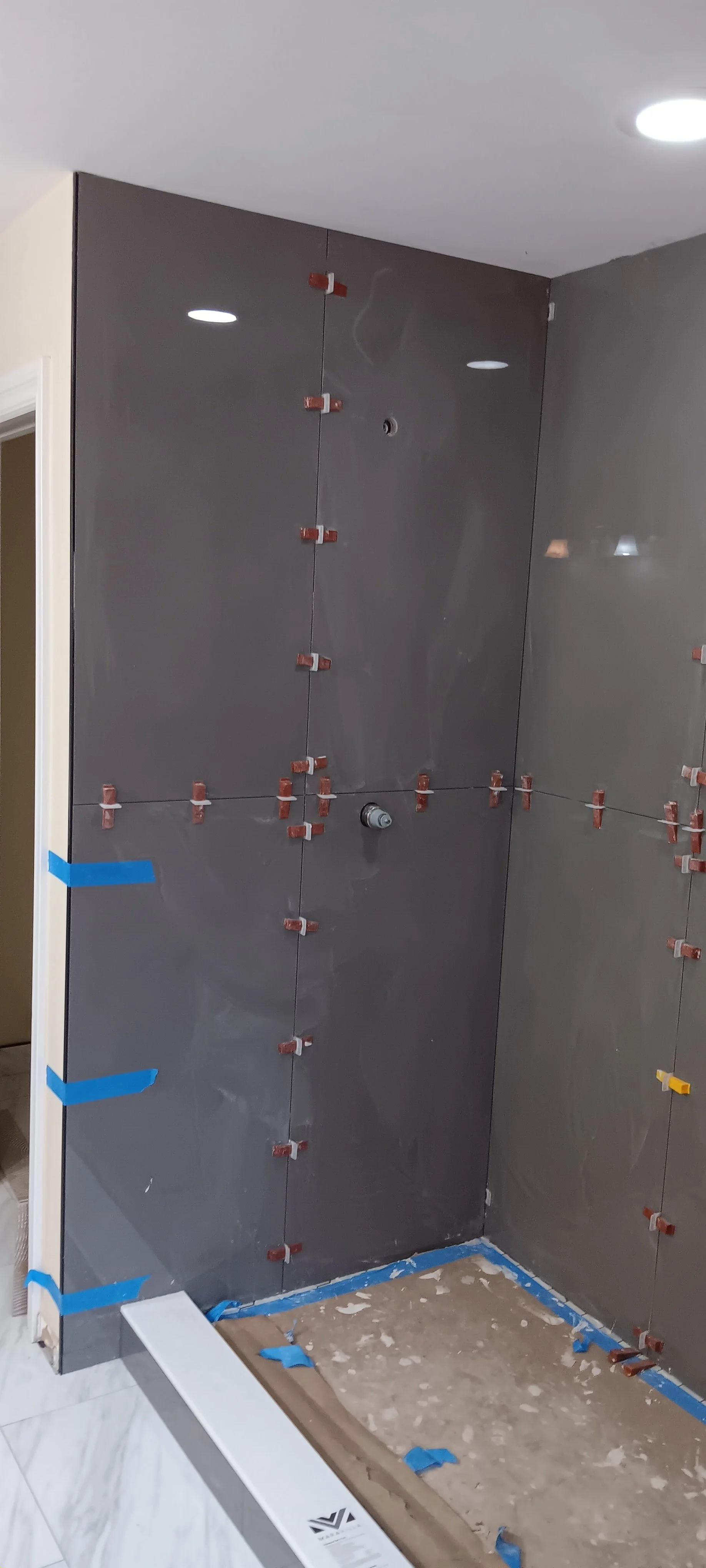 Dark wall tile installed inside the custom walk-in shower.