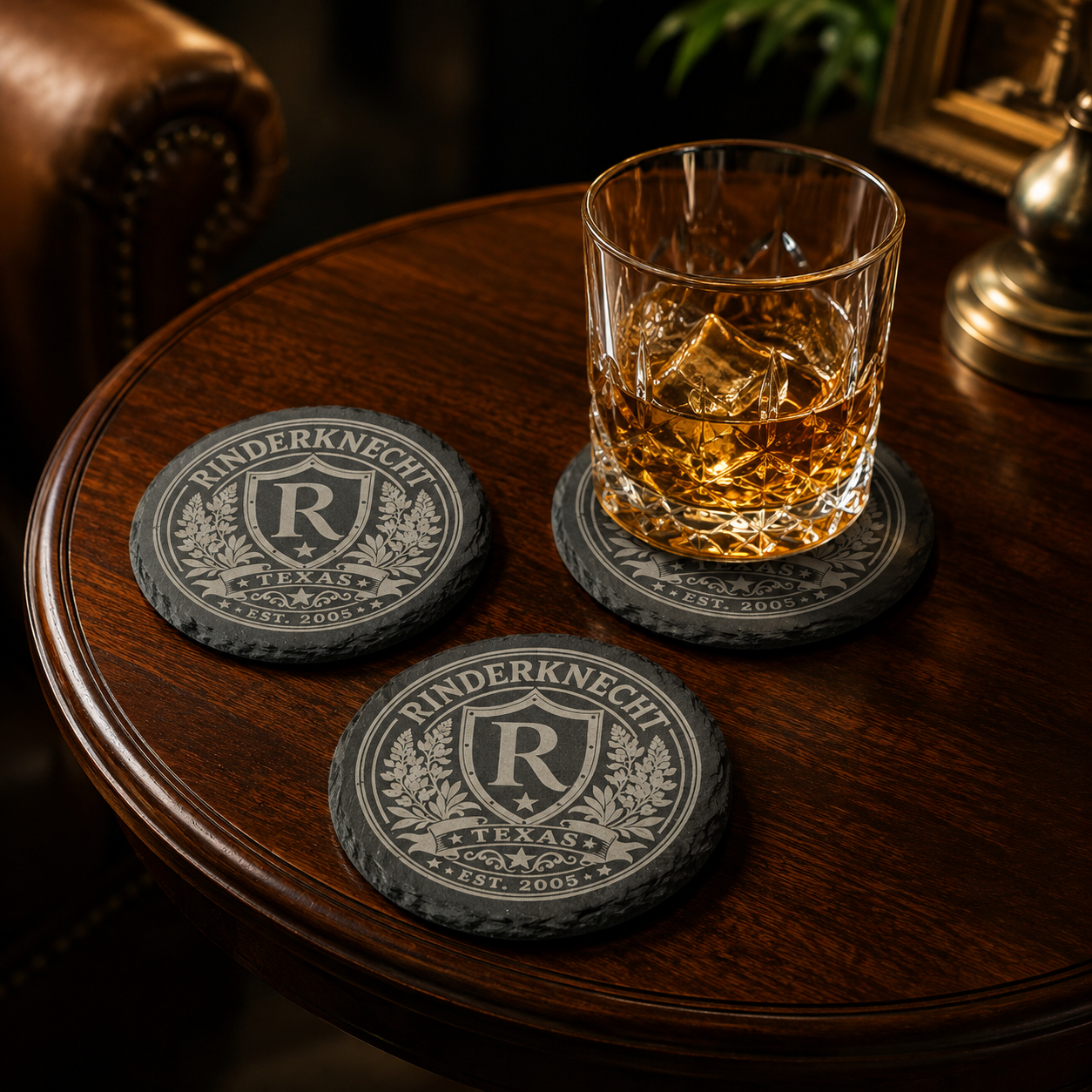 Custom engraved slate coasters featuring a personalized family crest design.