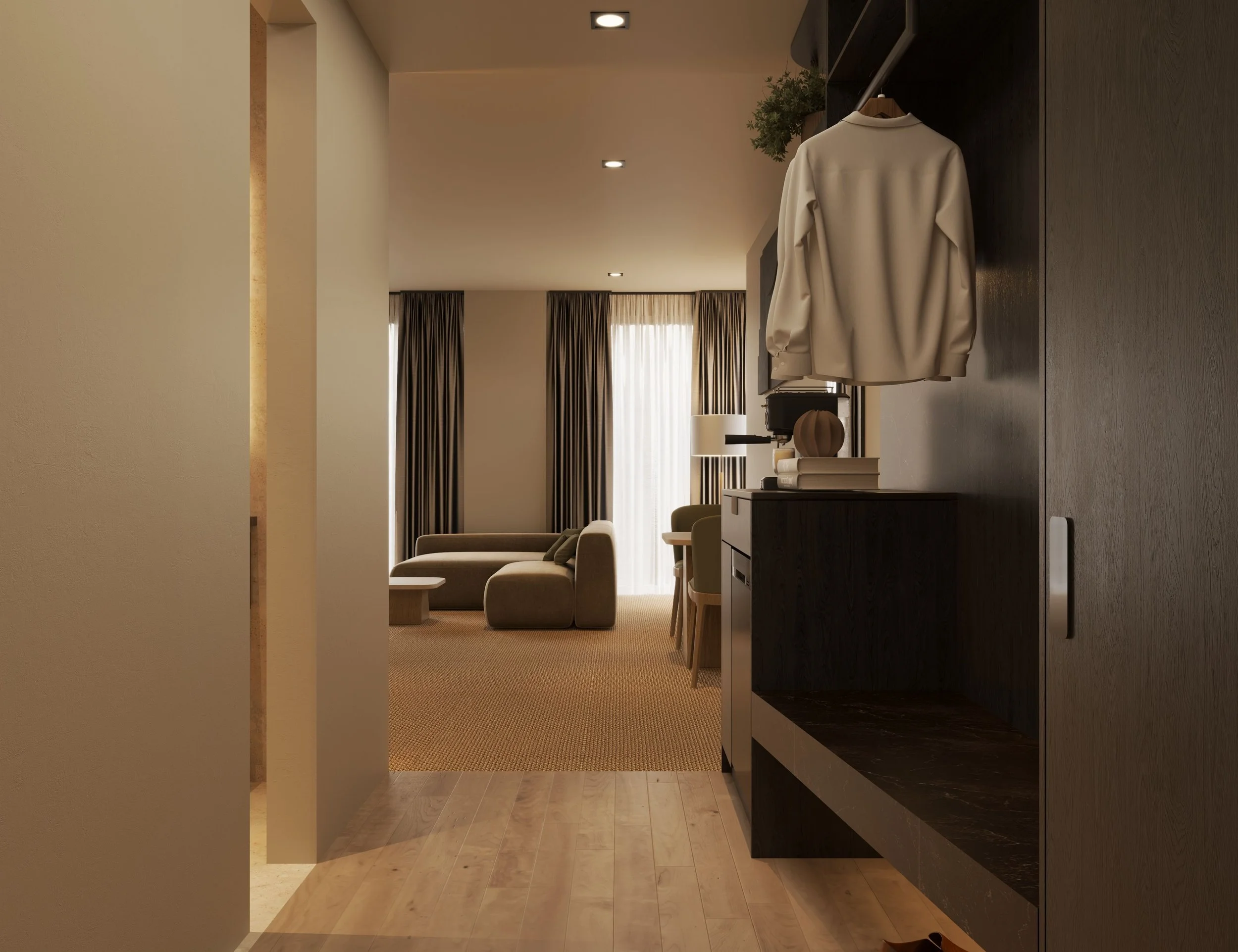 View of a modern living room with beige armchairs, dark curtains, and large windows, seen through an open doorway from an entryway that has a dark wood shelf and a white jacket hanging.