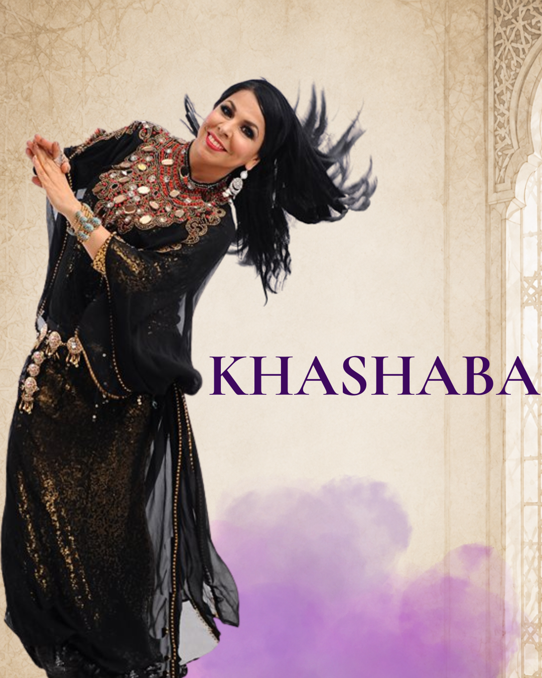 A woman with long black hair, wearing a black and gold traditional dress with intricate jewelry, smiling and posing with her hands in front of her against a beige background with an arched window frame design. The word "KHASHABA" is written in purple text on the lower right.
