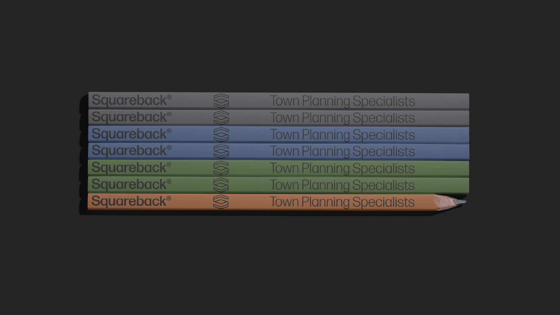 A stack of six colored pencils stacked horizontally, with the text 'Squareback' and 'Town Planning Specialists' on each, in shades of gray, blue, green, and orange.