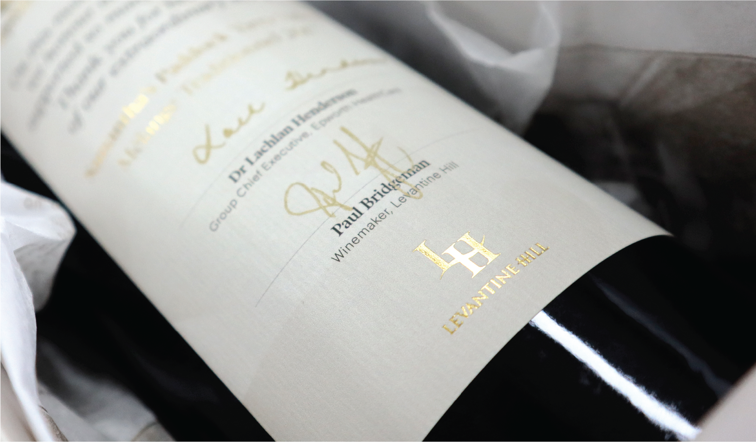 Close-up of a wine bottle label with gold lettering, including the name Paul Bridgeman and the winery Le Domaine Hill.