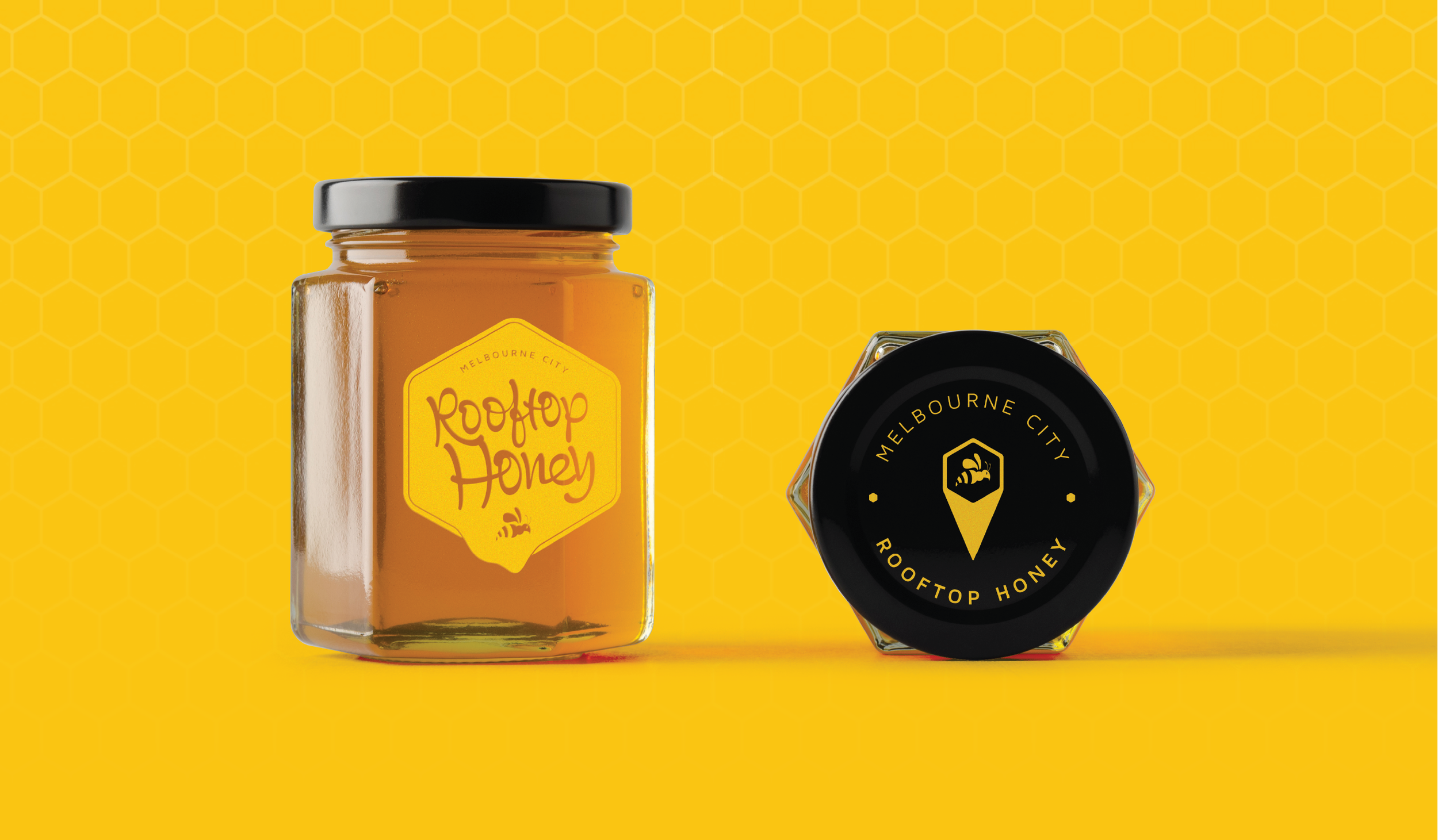 A jar of Rooftop Honey with a yellow honey label and a black lid, set against a yellow background with a honeycomb pattern. Next to it is a black container with a yellow and black label that reads 'Melbourne City Rooftop Honey' and features a honey dipper icon.