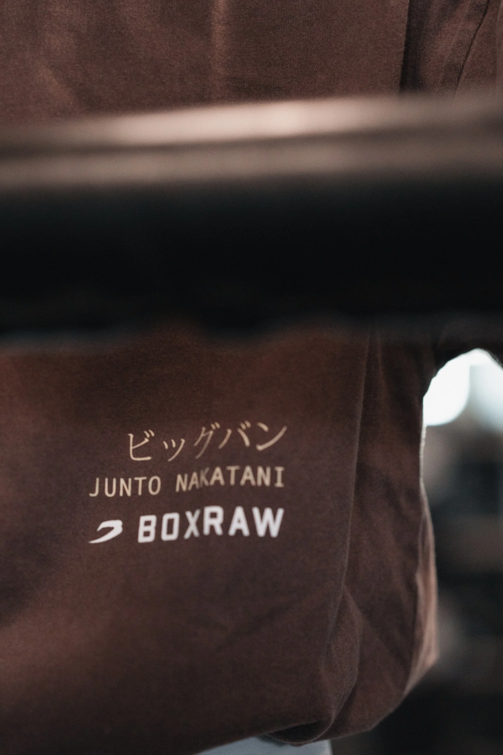 Close-up of a brown cardboard box with white text that reads "JUNTO NAKATANI 2 BOXRAW."