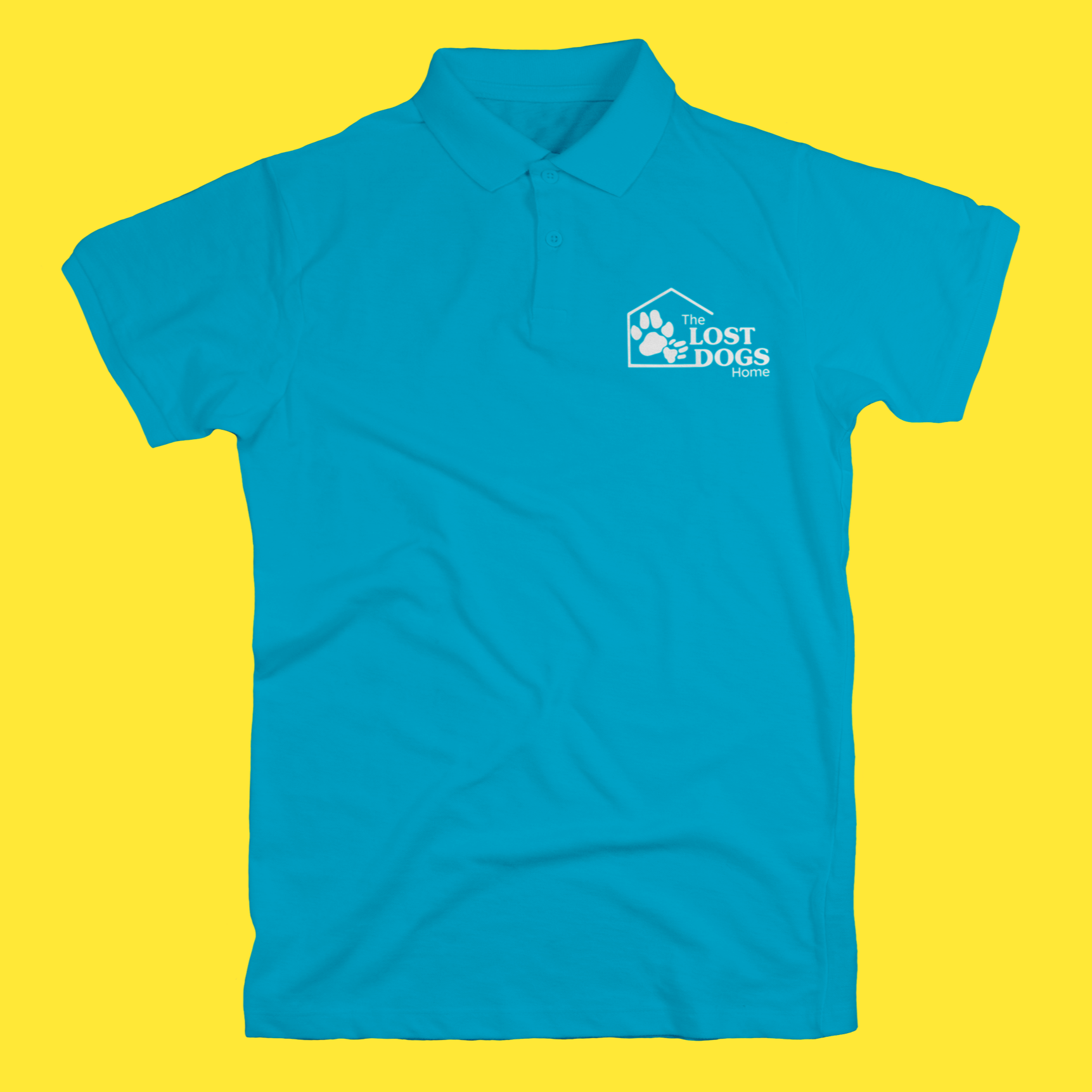 Blue polo shirt with logo of a paw print inside a house outline and text "The Lost Dogs Home" on the left chest.