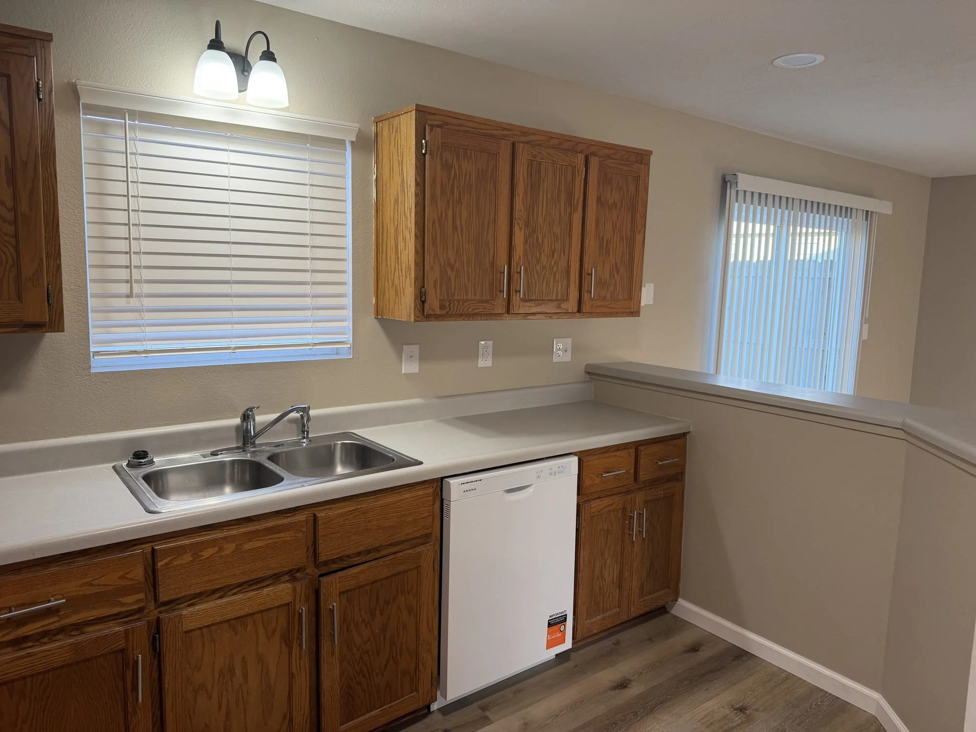  Kitchen with double sink, dishwasher, and oak cabinetry in this Lebanon, MO rental. 