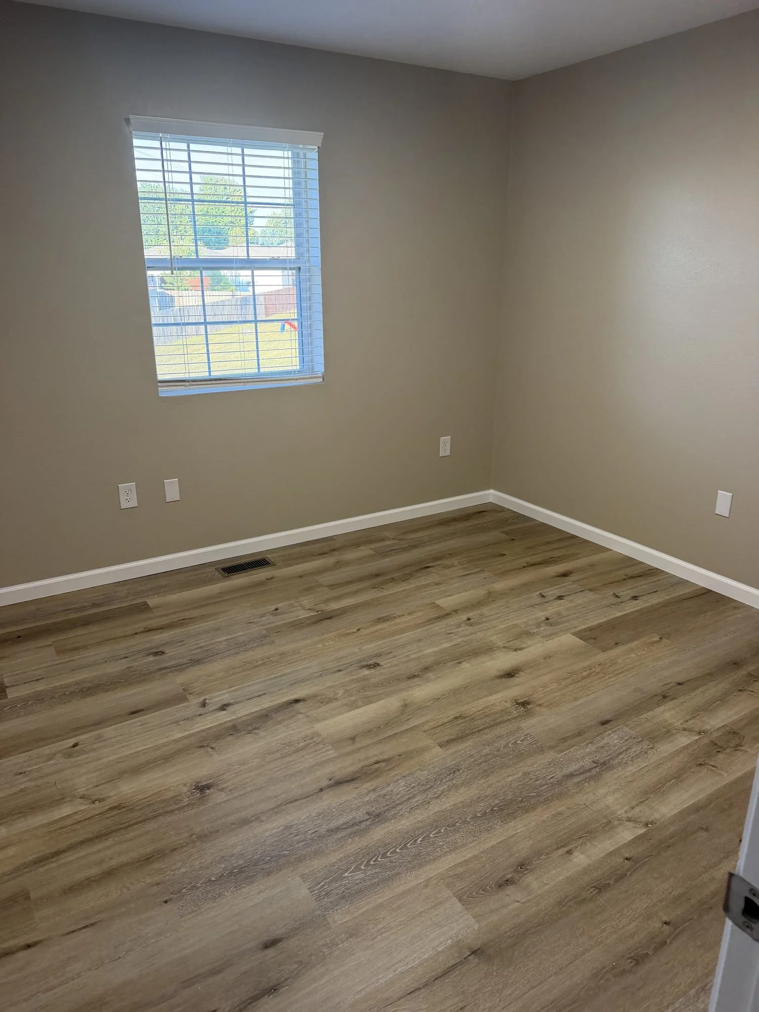  Bedroom with window and laminate flooring, Lebanon MO townhouse rental. 
