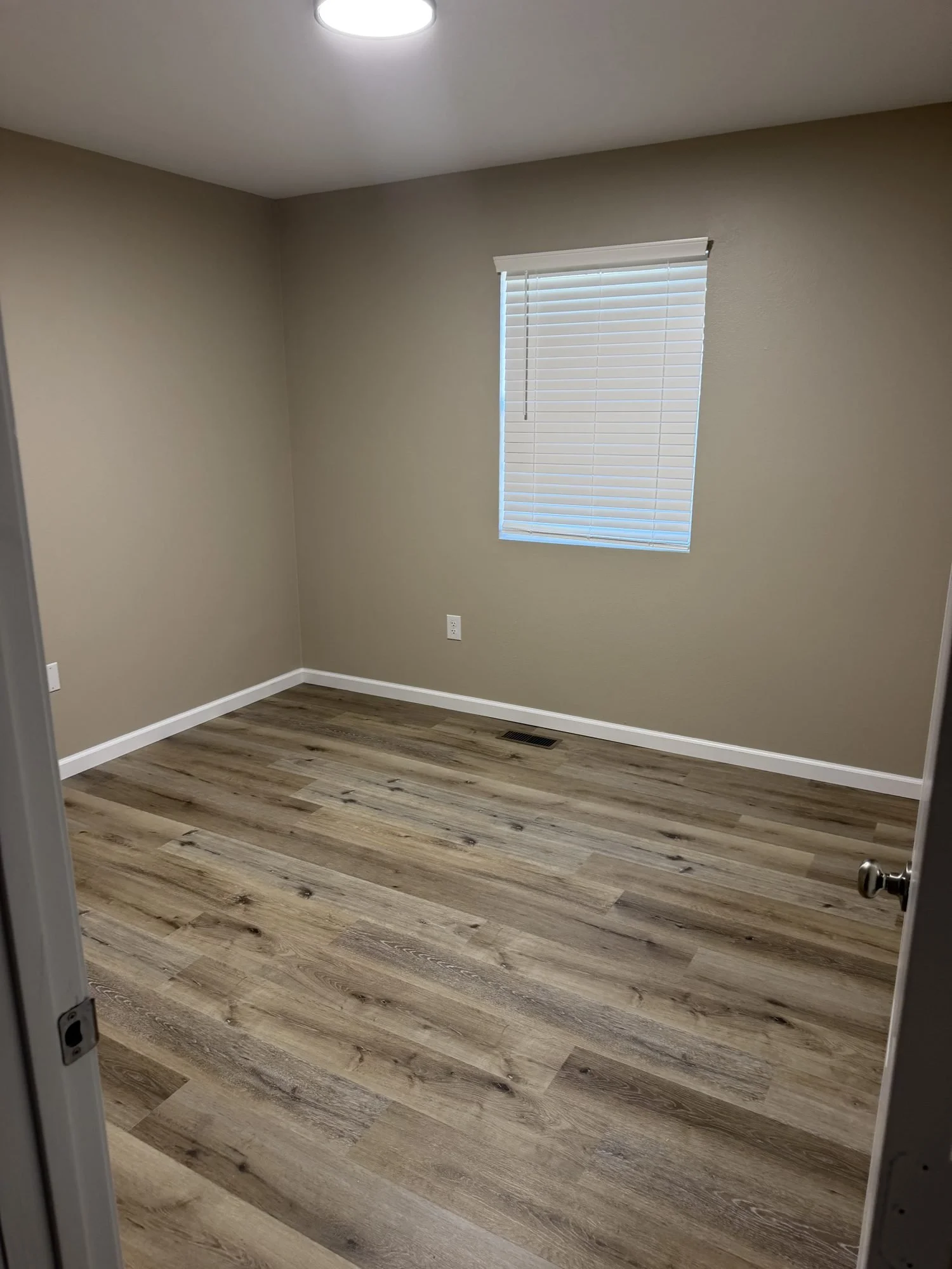  Second bedroom with natural light and laminate floors in a Lebanon, MO rental. 