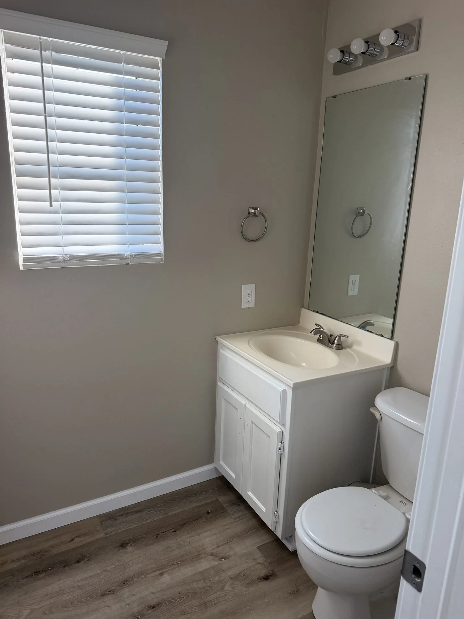  Half bath with vanity, mirror, and toilet in this Lebanon, MO rental home. 