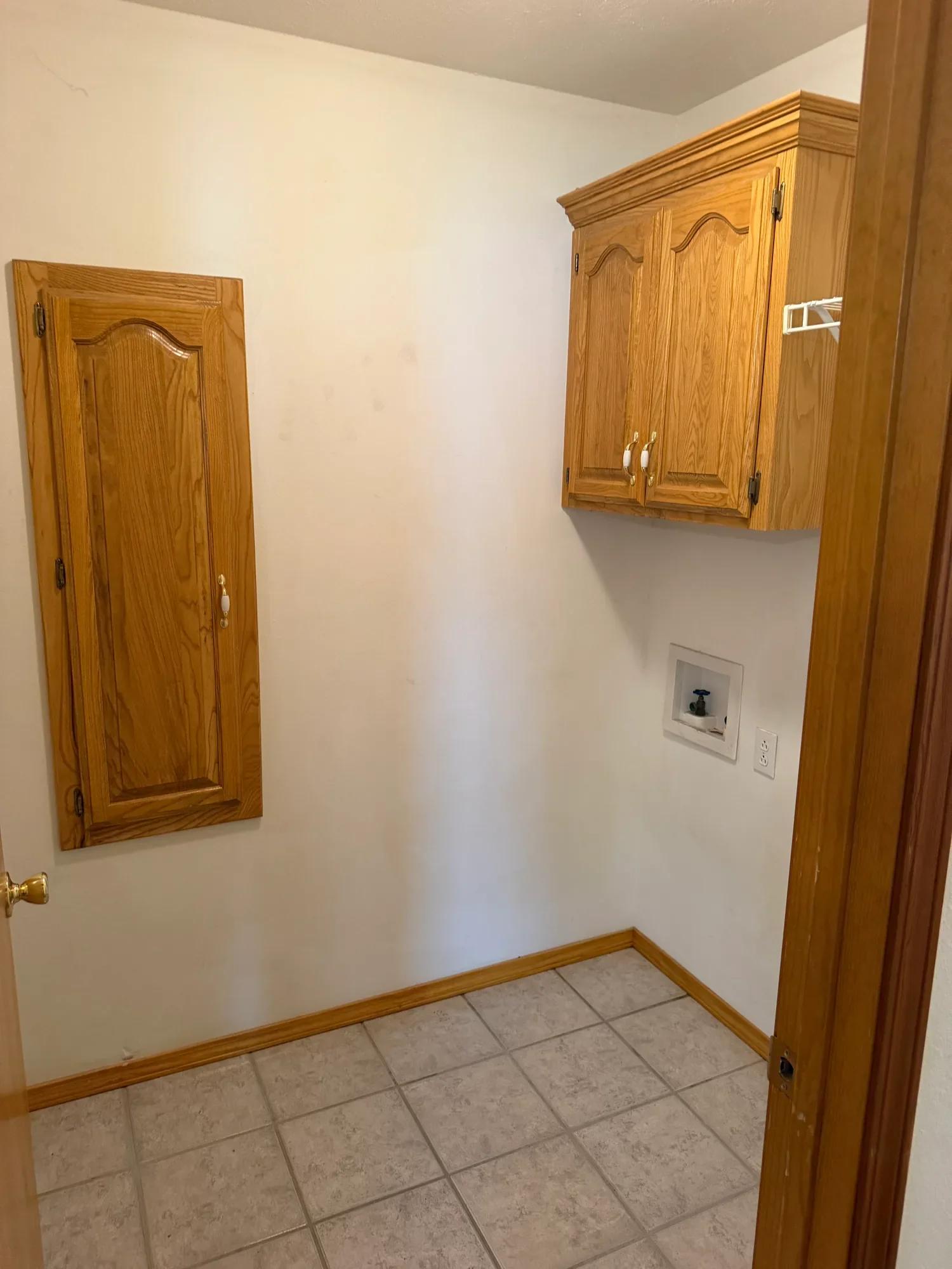  Laundry room with tile floor, washer hookups and oak wall cabinet 