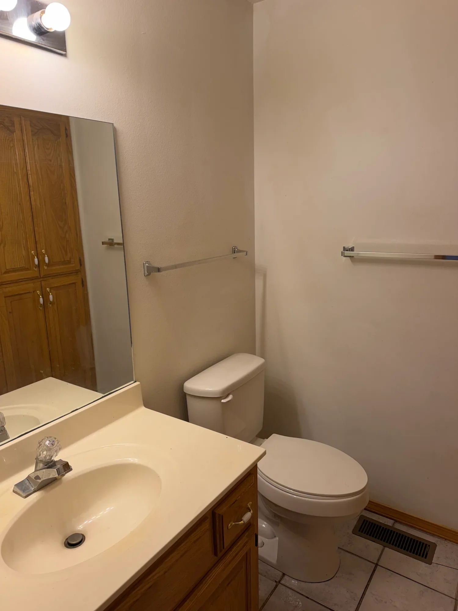  Bathroom with vanity, large mirror and toilet 