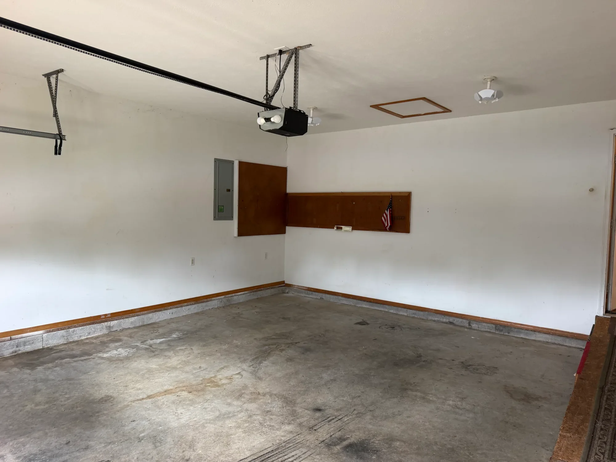  Garage interior with overhead storage and wall shelf 