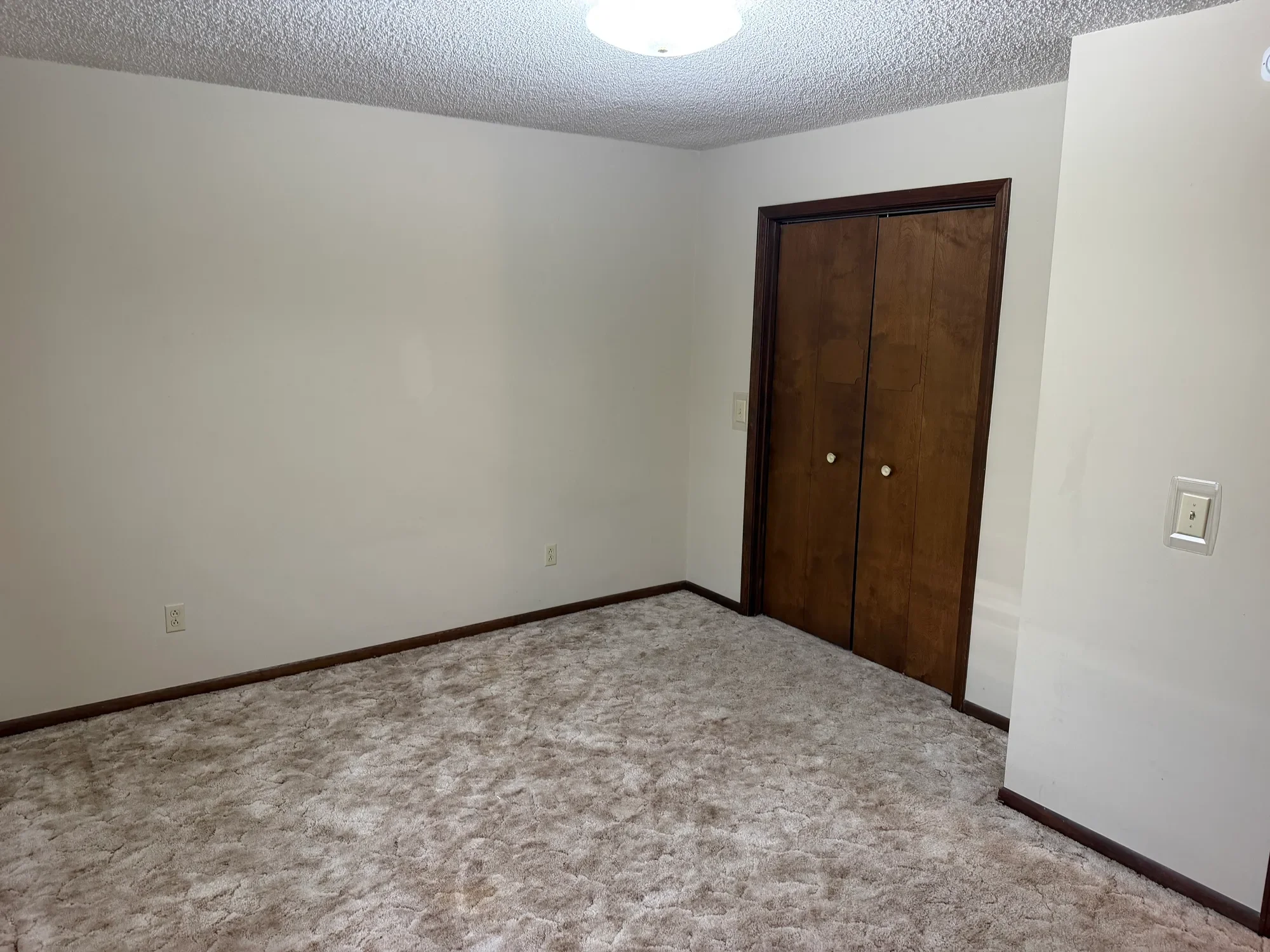  Carpeted bedroom with a double door closet 