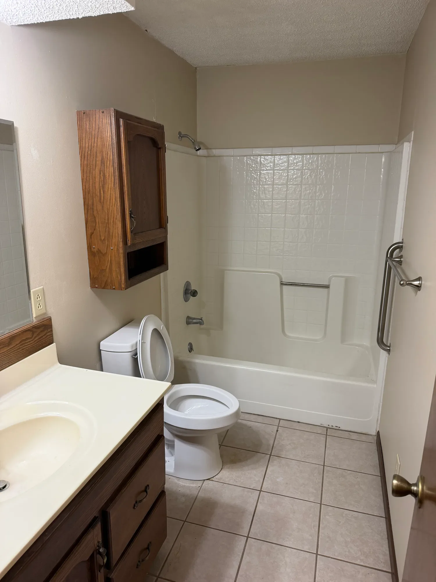  Bathroom with tub and shower combo, vanity, and tile floor 