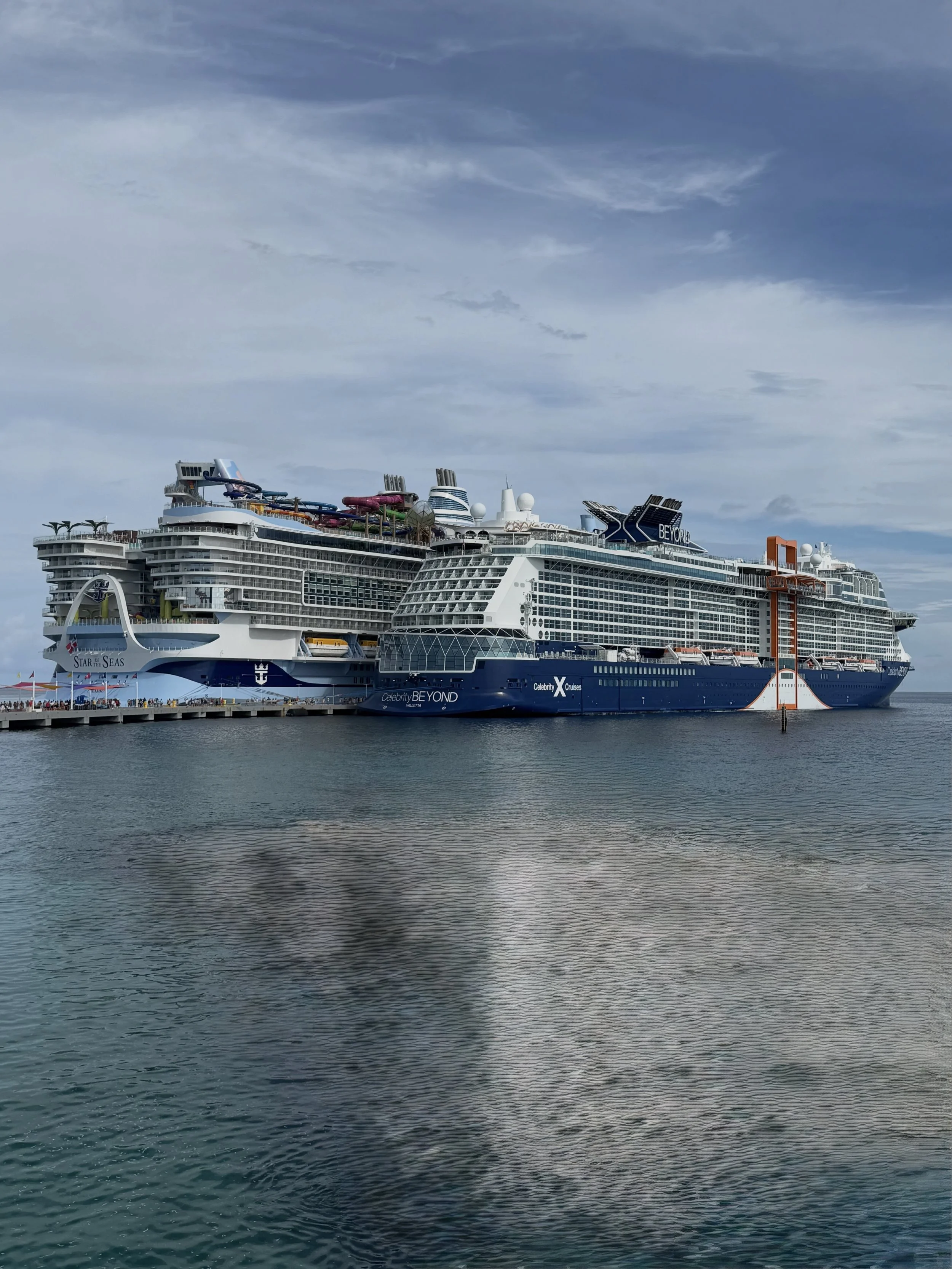 Crucero atracado en un puerto bajo un cielo parcialmente nublado.