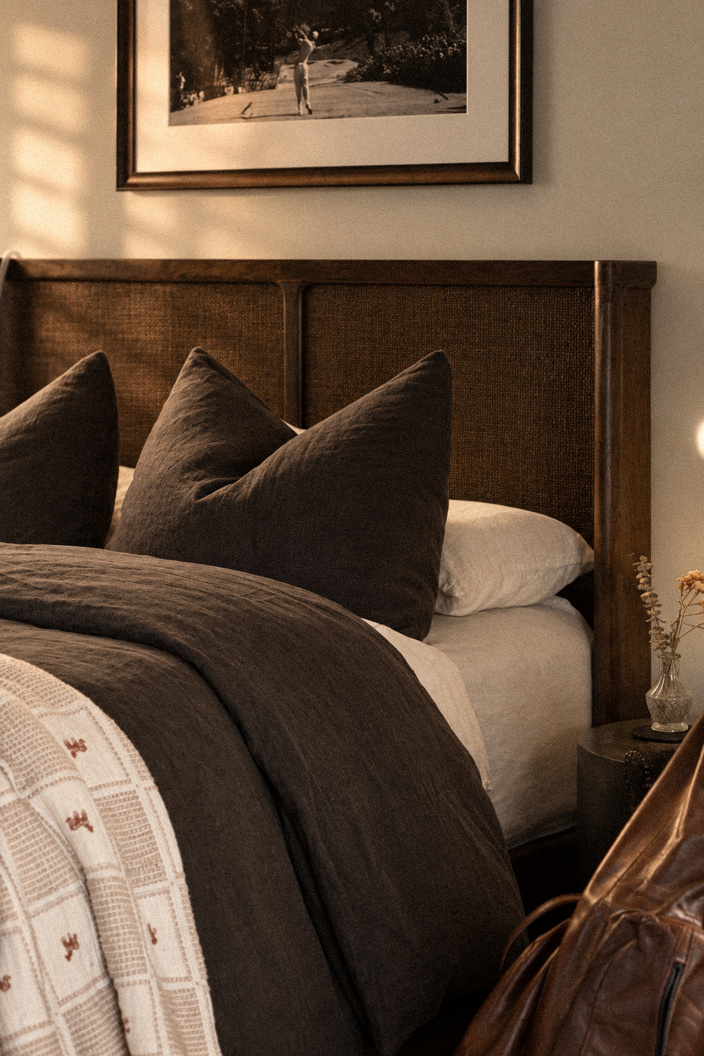 A cozy bedroom curated with layers of rich, beautifully styled bedding, warm textures, and bespoke details. Every element is thoughtfully selected to create an atmosphere of effortless, high-end comfort.
