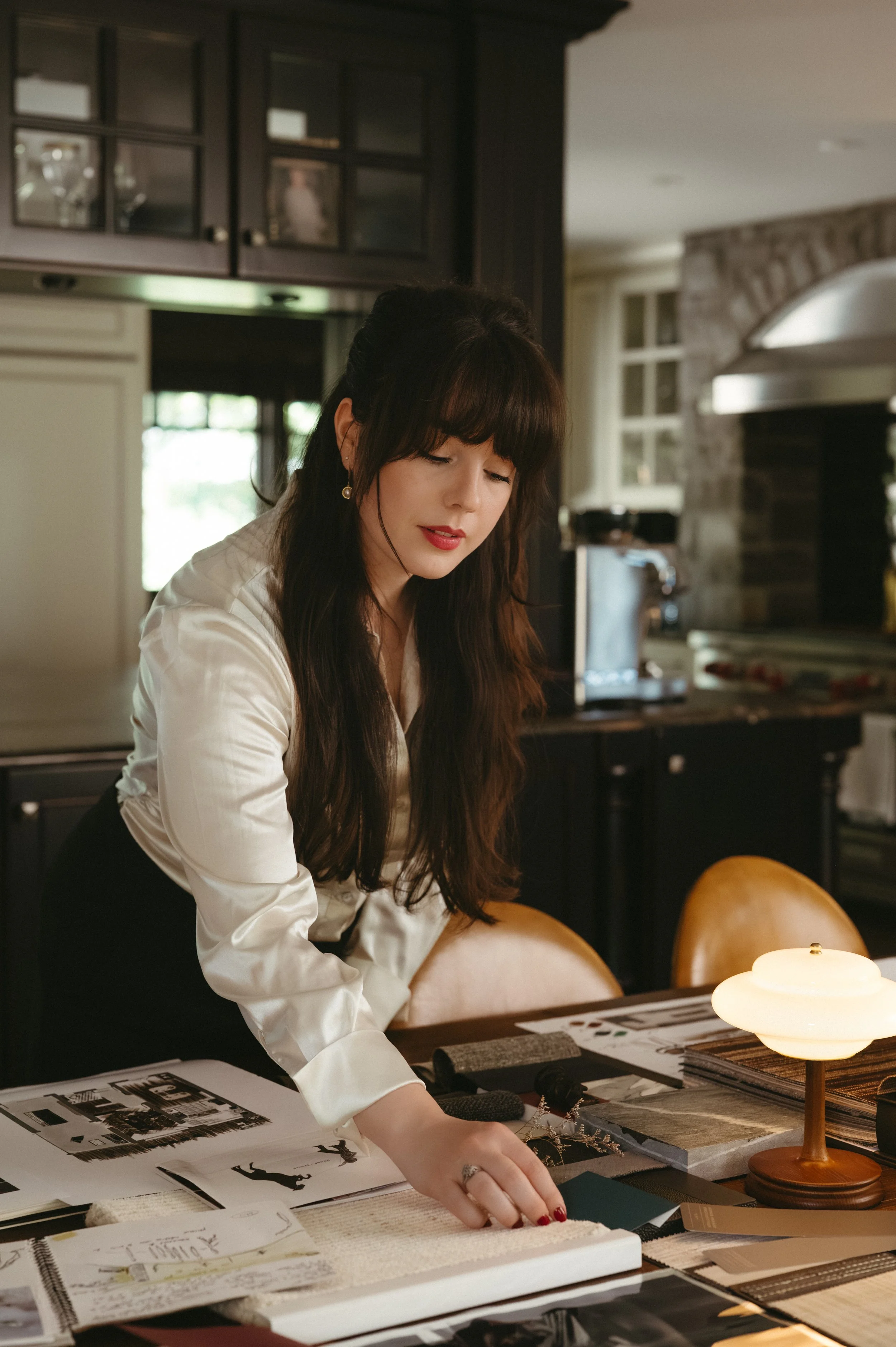 Iris Humbert thoughtfully composing a palette, mixing swatches: fabrics, textures, colors and materials to create a harmonious and layered interior. Elements are carefully considered and intentionally combined to create depth, warmth and character.