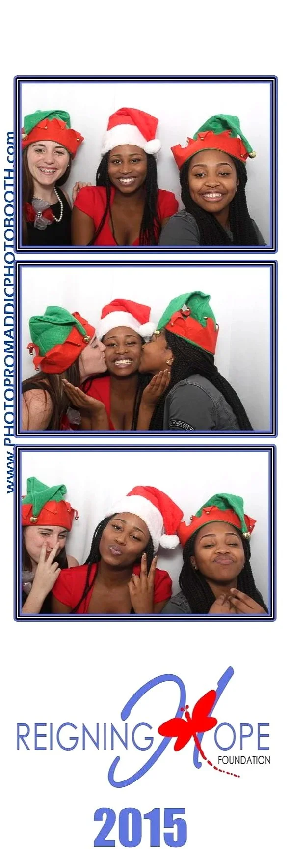 Three women wearing festive Christmas hats smiling, kissing, and posing in a photo booth with a 'Reigning Hope Foundation 2015' logo at the bottom.