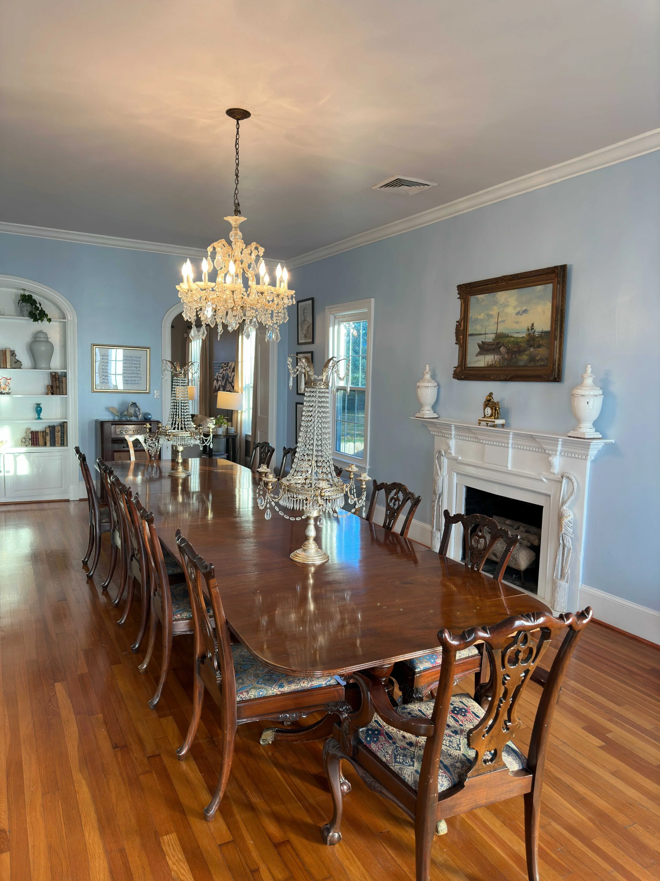 Elegant blue dining room with crystal chandelier and long table at Amelie Beau venue