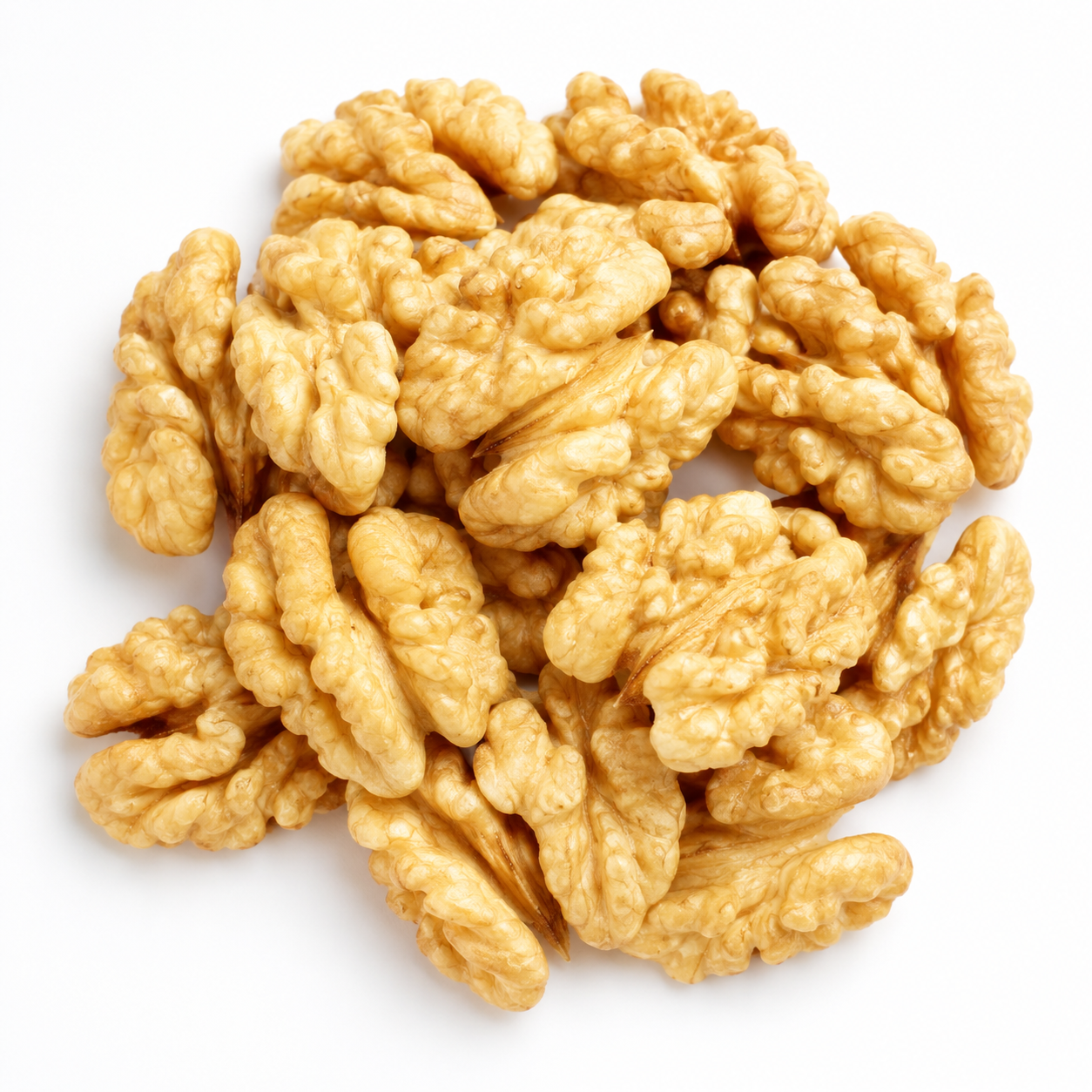 Pile of walnut halves on a white surface