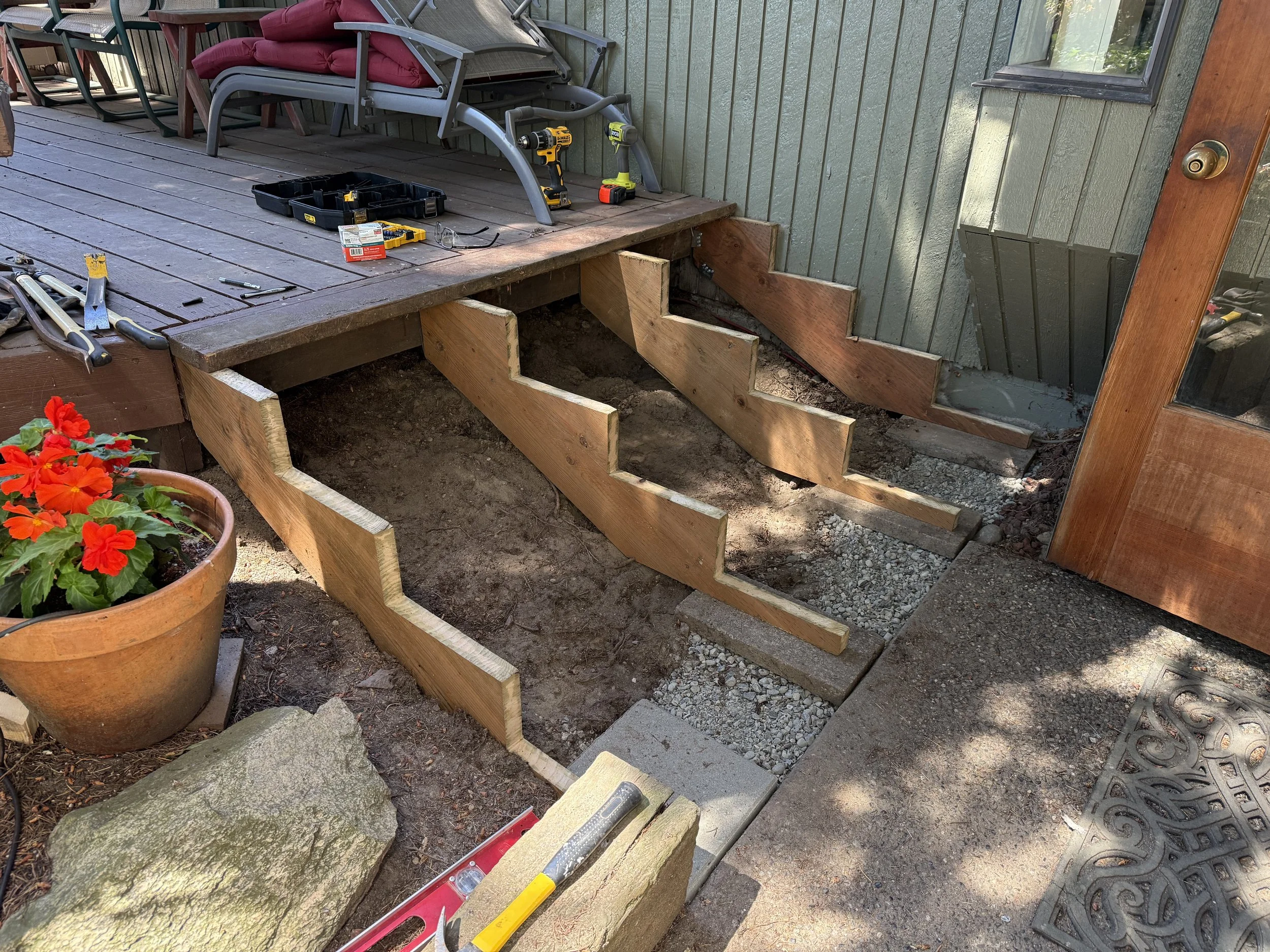 New stair stringers and structure build from the ground up, reusing the original deck boards where possible.