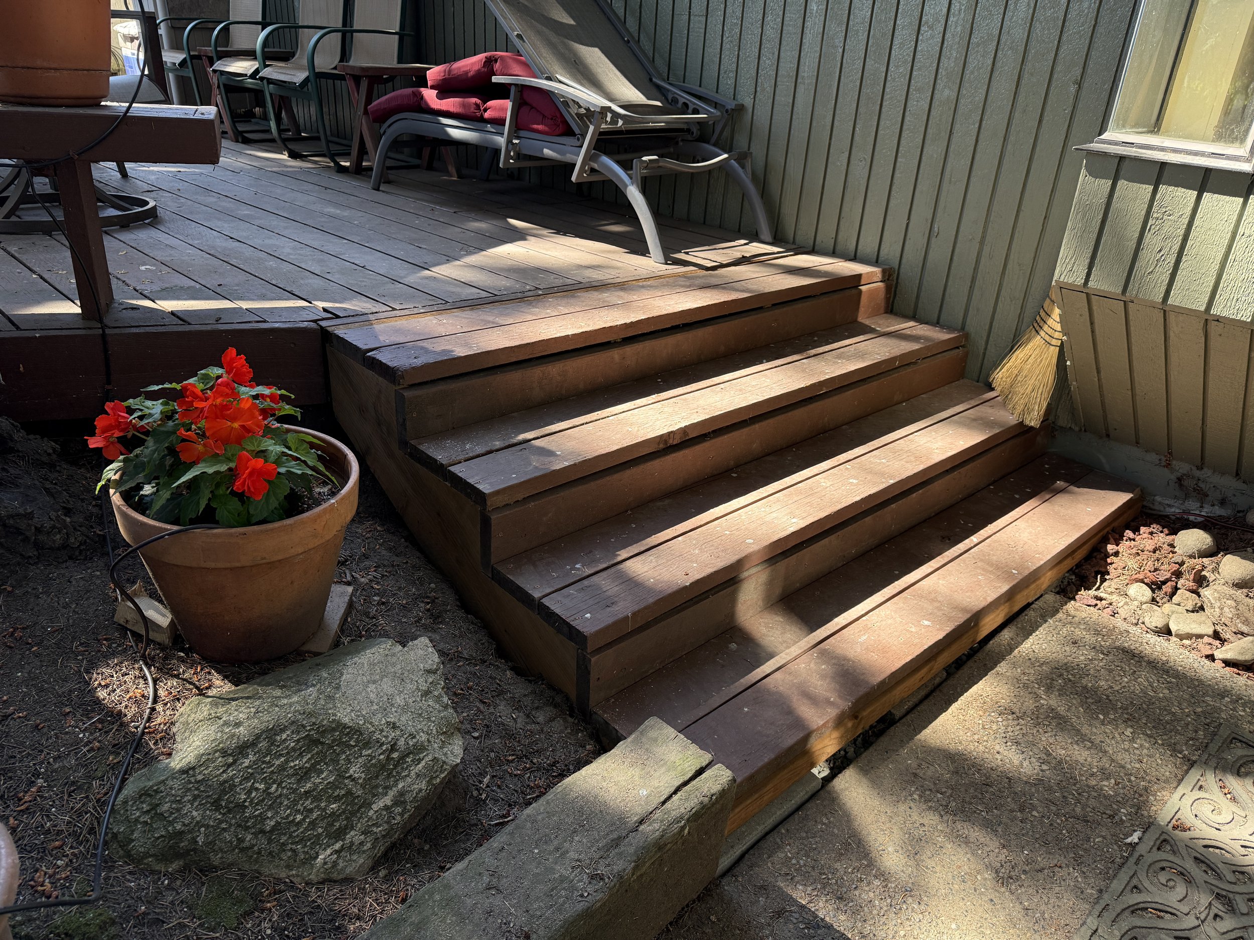 Completed exterior step rebuild, combining new construction with salvaged original decking. 