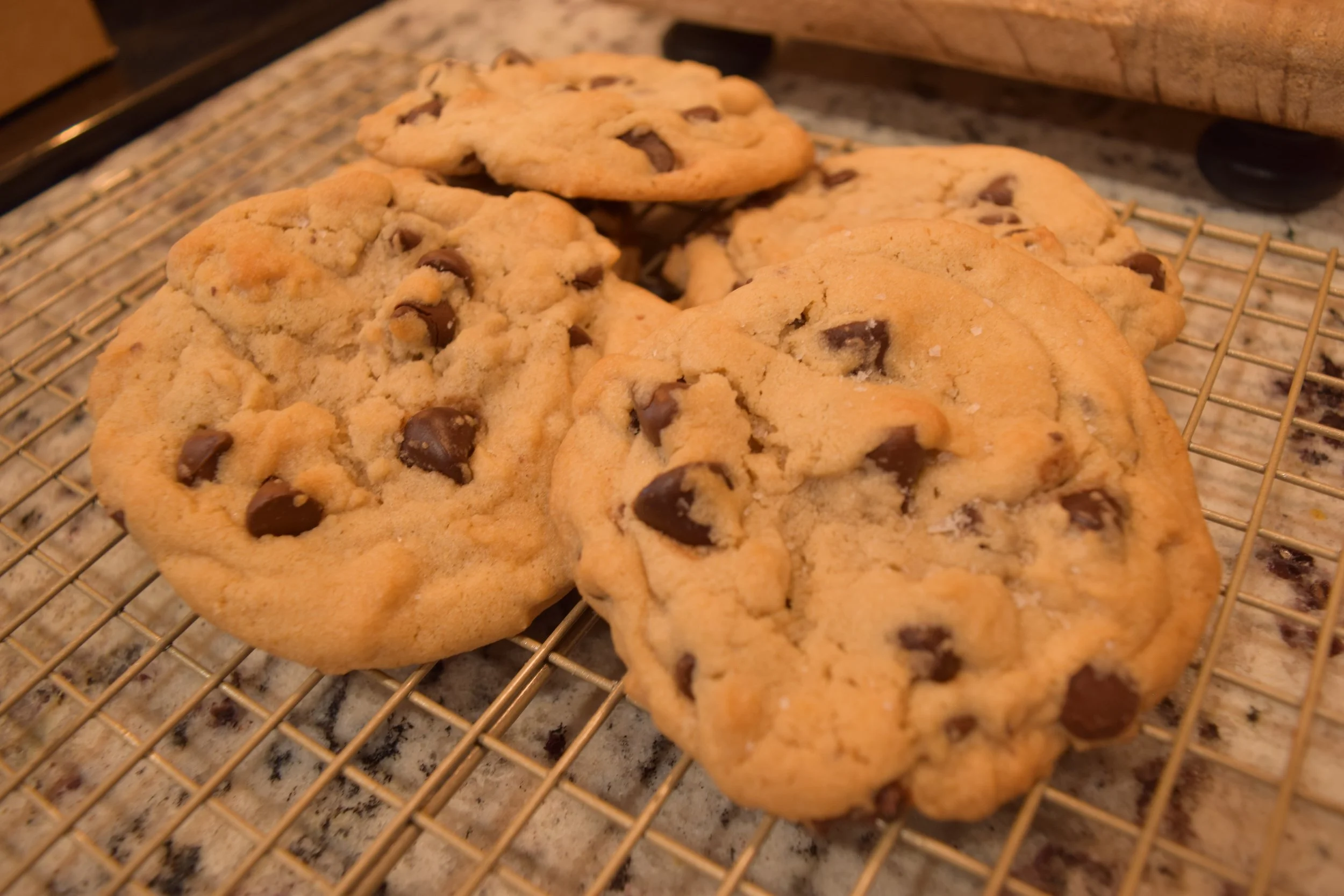 Chocolate chip tahini cookies cooling on a wire rack