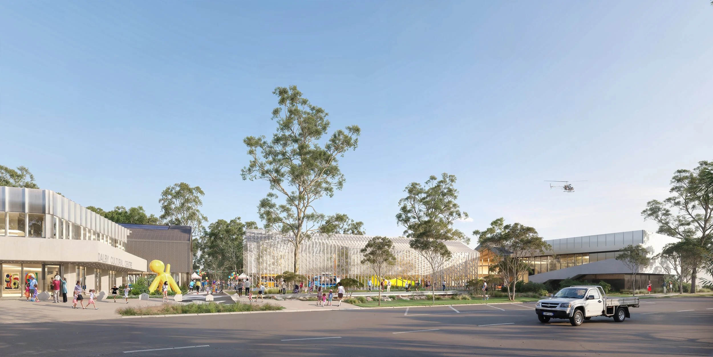 An outdoor scene of a cultural center with people walking and children playing, surrounded by trees and modern architecture, with a clear sky overhead.