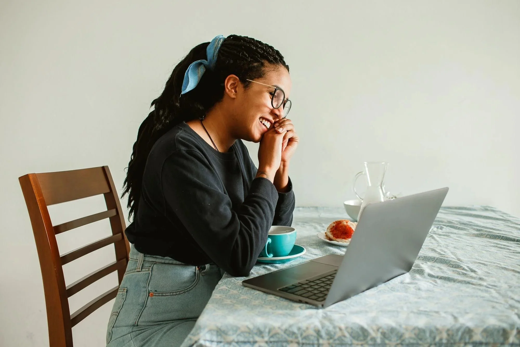 A person laughs during a virtual therapy session.