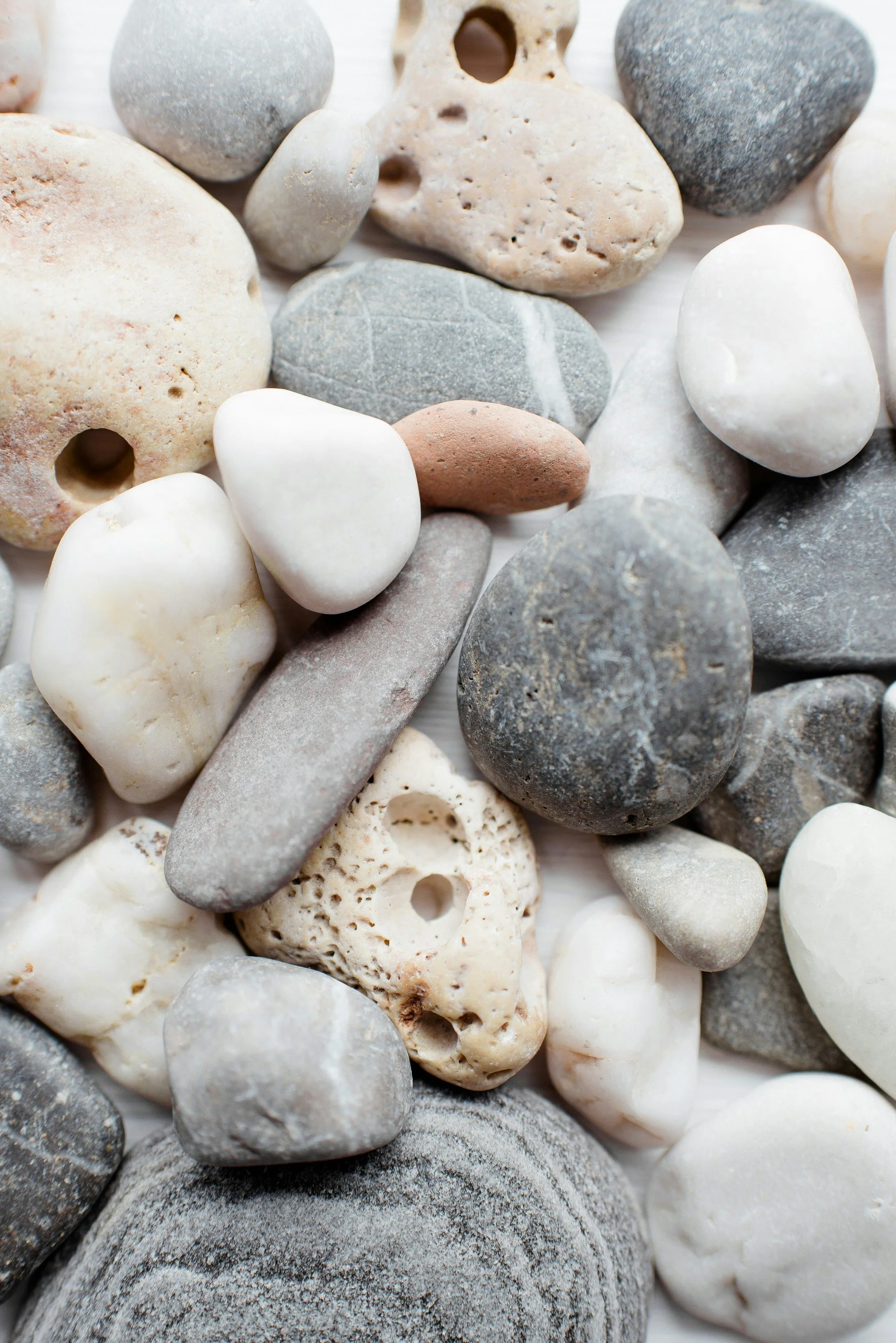 A pile of rocks in serene whites, light grays, and oranges.